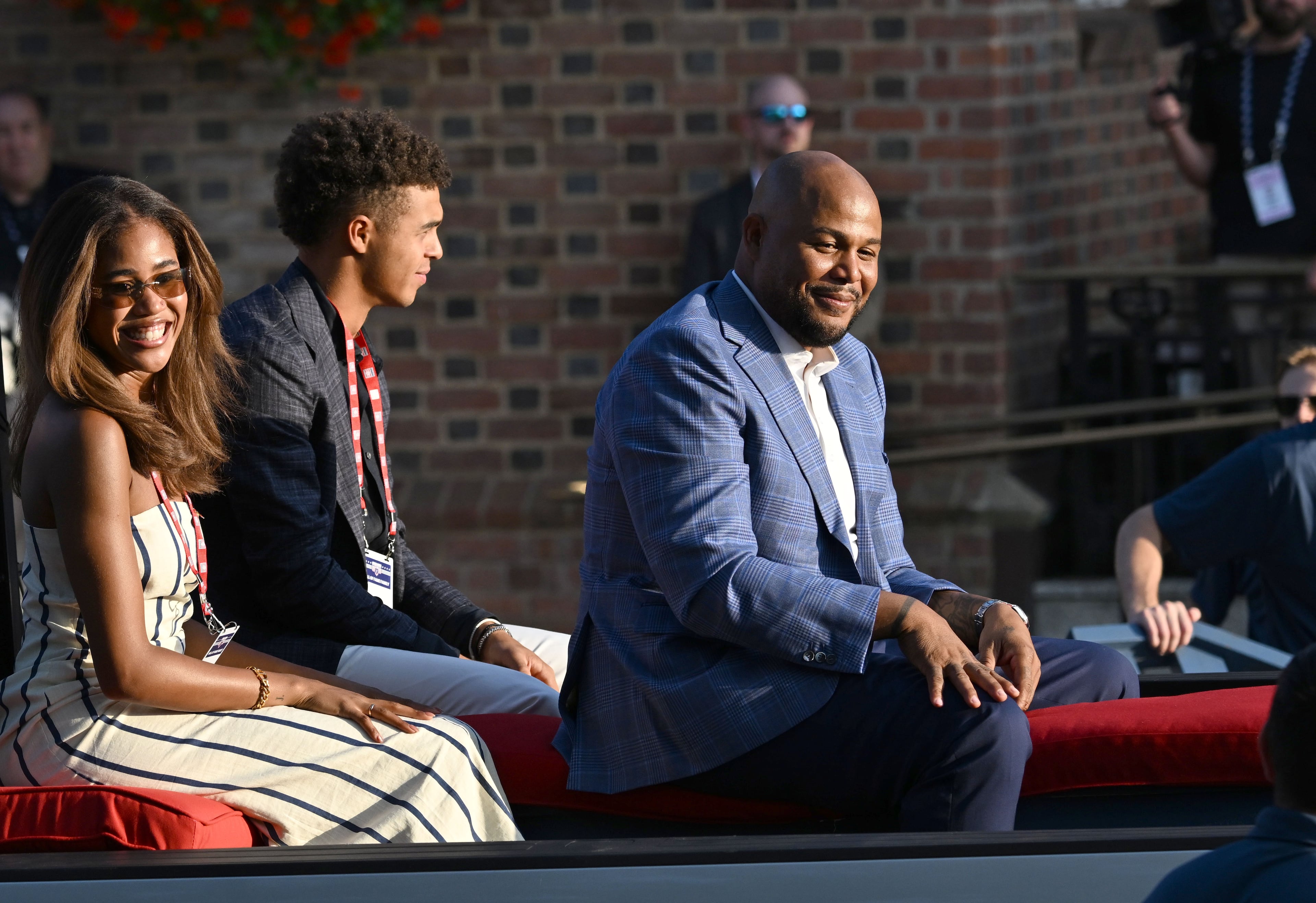 Former Brave Andruw Jones (right) and his family react during the Hall of Fame Legends Parade on Saturday, July 25, 2026, in Cooperstown, N.Y. Jones will be inducted into the National Baseball Hall of Fame on Sunday as part of the Class of 2026, alongside Carlos Beltrán and Jeff Kent. (Hyosub Shin/AJC)