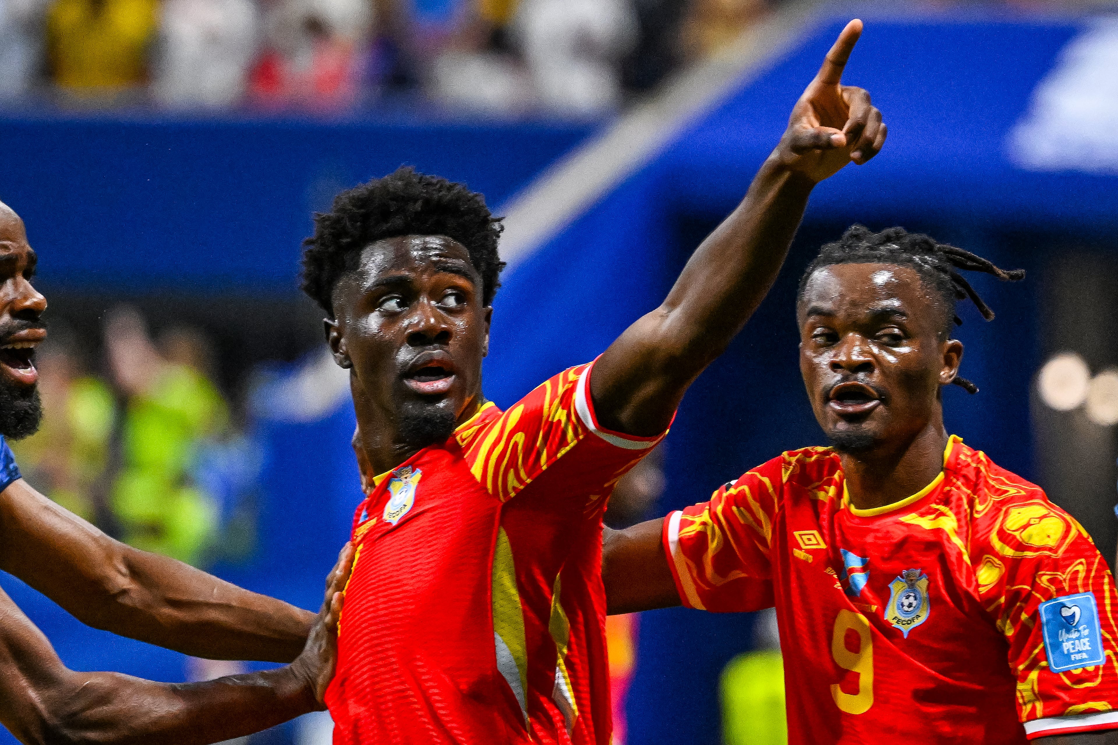 Congo forward Nathanaël Mbuku (left) celebrates blocking an attempted Uzbekistan goal during the first half of a FIFA World Cup match at Atlanta Stadium (Mercedes-Benz Stadium) on Saturday, June 27, 2026, in Atlanta. (Hyosub Shin/AJC)