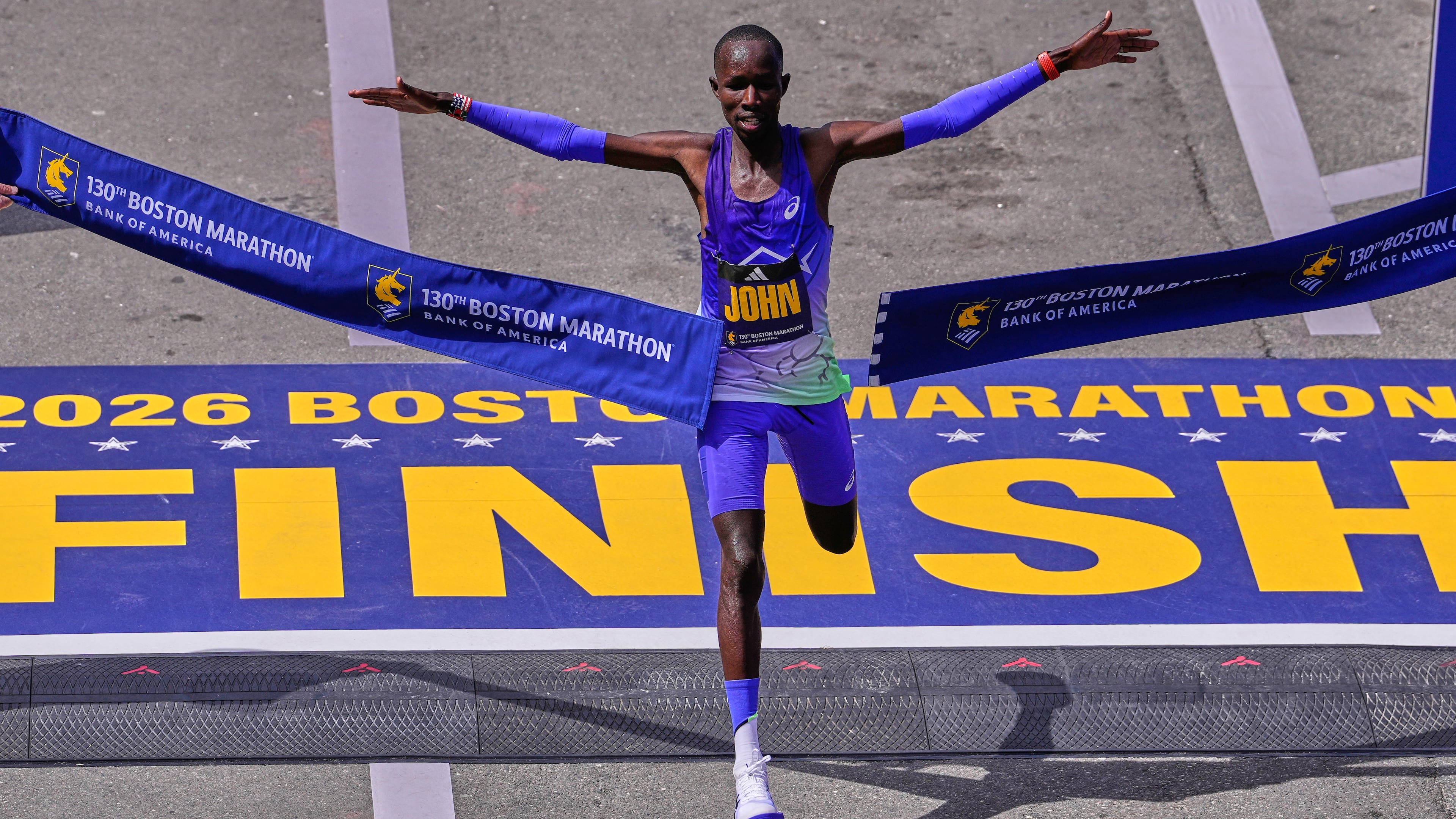 John Korir, of Kenya, breaks the tape to win the Boston Marathon, Monday, April 20, 2026, in Boston. (AP Photo/Charles Krupa)