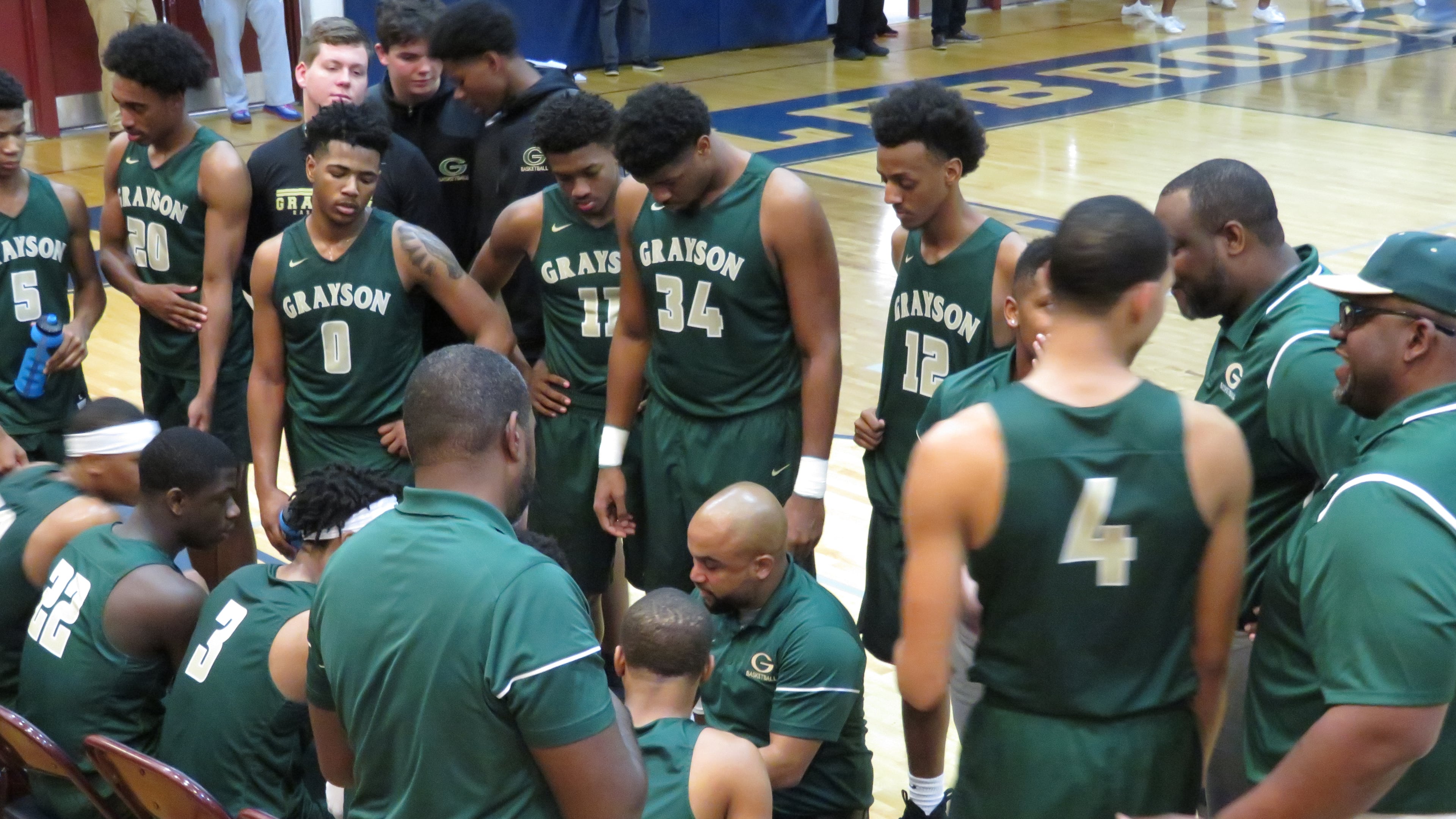 Grayson coach Geoffrey Pierce (kneeling) has the Rams (15-1) ranked No. 1 in Class 6A. The Rams lost three players who transferred but had five transfers in, including Class of 2026 5-star Caleb Holt, ranked No. 3 overall in his class by the 247Sports composite rankings, who moved in from Alabama.