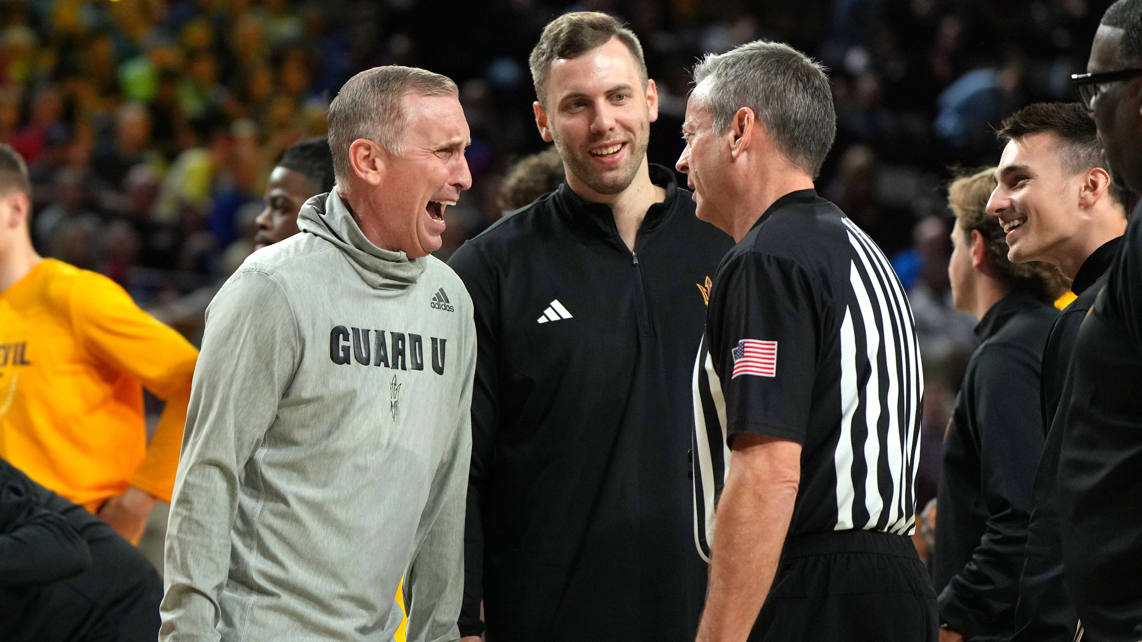 Arizona State head coach Bobby Hurley talks with a referee during the first half of an NCAA college basketball game against Kansas, Tuesday, March 3, 2026, in Tempe, Ariz. (AP Photo/Rick Scuteri)