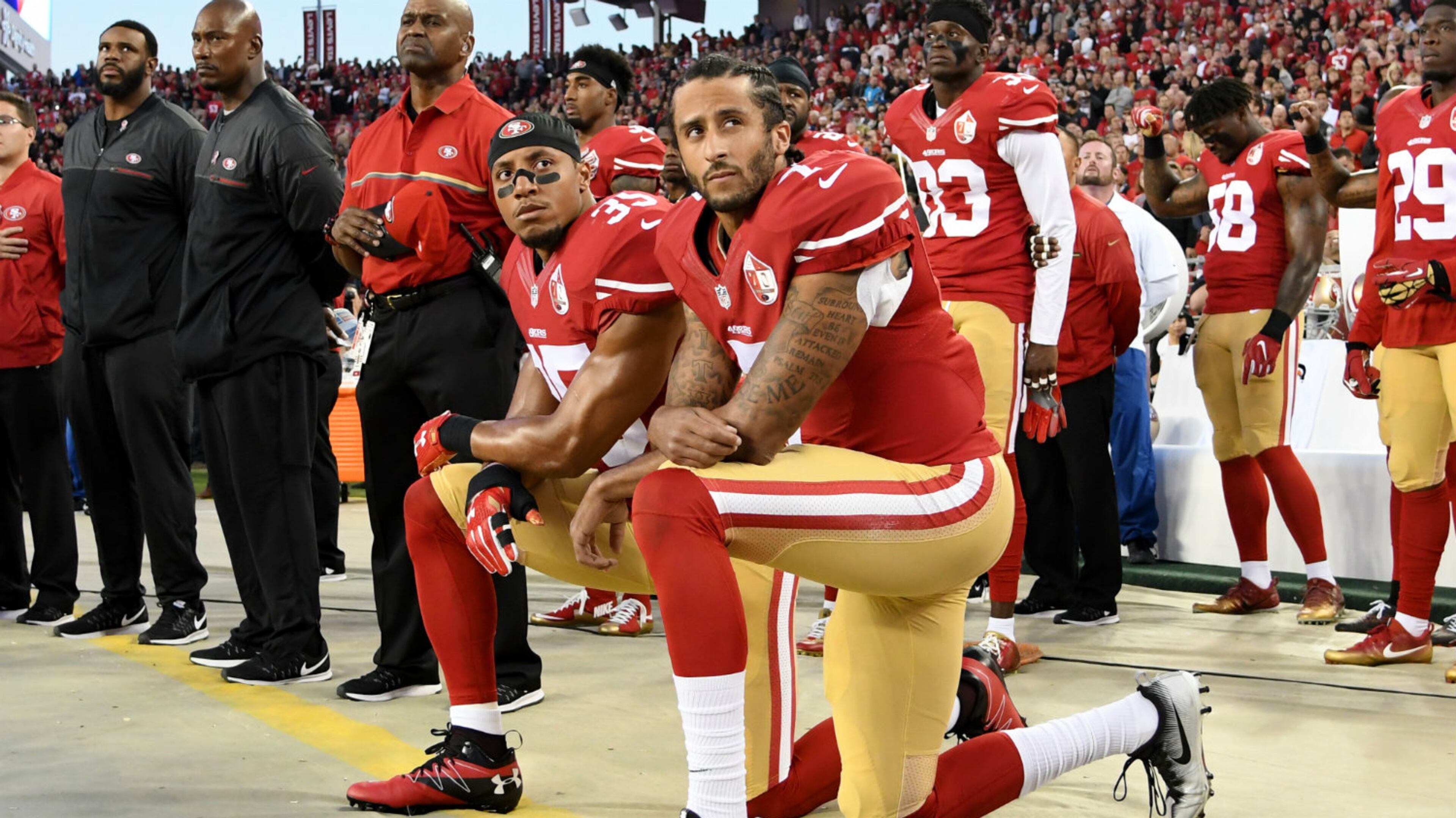 SANTA CLARA, CA - SEPTEMBER 12: Colin Kaepernick #7 and Eric Reid #35 of the San Francisco 49ers kneel in protest during the national anthem prior to playing the Los Angeles Rams in their NFL game at Levi's Stadium on September 12, 2016 in Santa Clara, California. (Photo by Thearon W. Henderson/Getty Images)