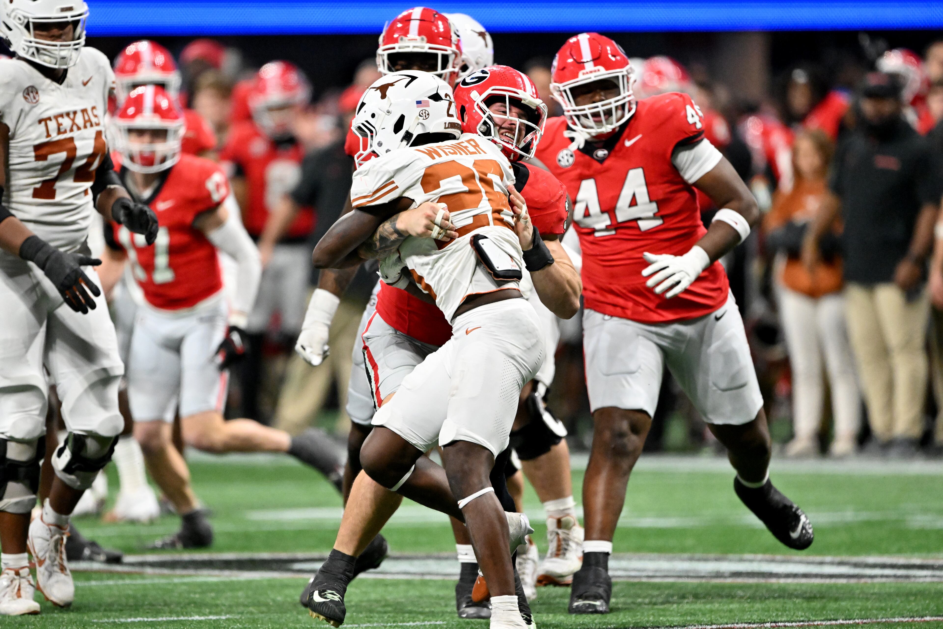 Georgia linebacker Chaz Chambliss (32) stops Texas running back Quintrevion Wisner (26) during the second half in the SEC Championship football game at the Mercedes-Benz Stadium, Saturday, December 7, 2024, in Atlanta. Georgia won 22-19 over Texas in overtime. (Hyosub Shin / AJC)