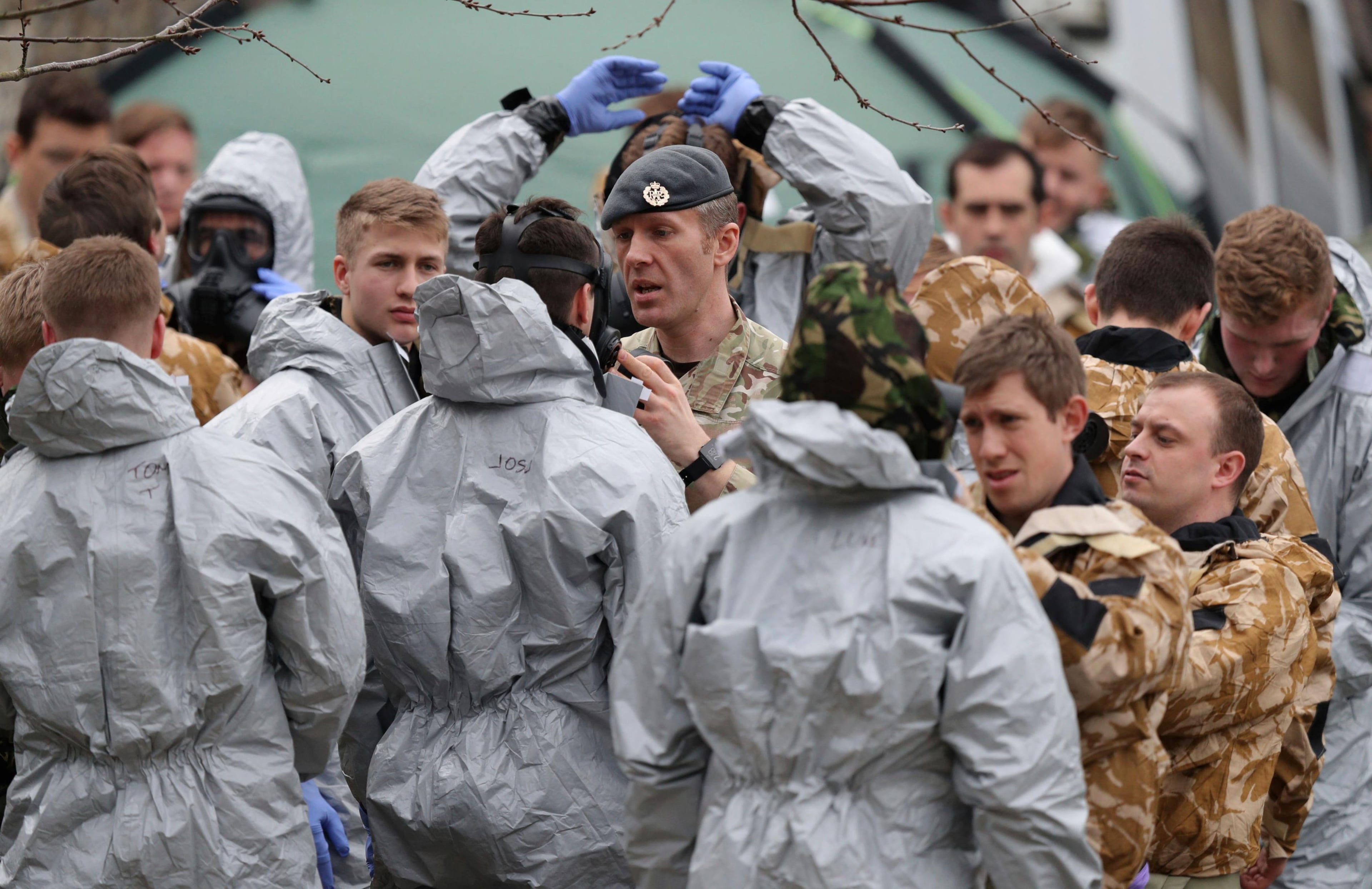 Military personnel are prepared before working to remove cars from a car park in Salisbury, England, as police and members of the armed forces probe the suspected nerve agent attack on Russian double agent spy Sergei Skripal, Sunday March 11, 2018.