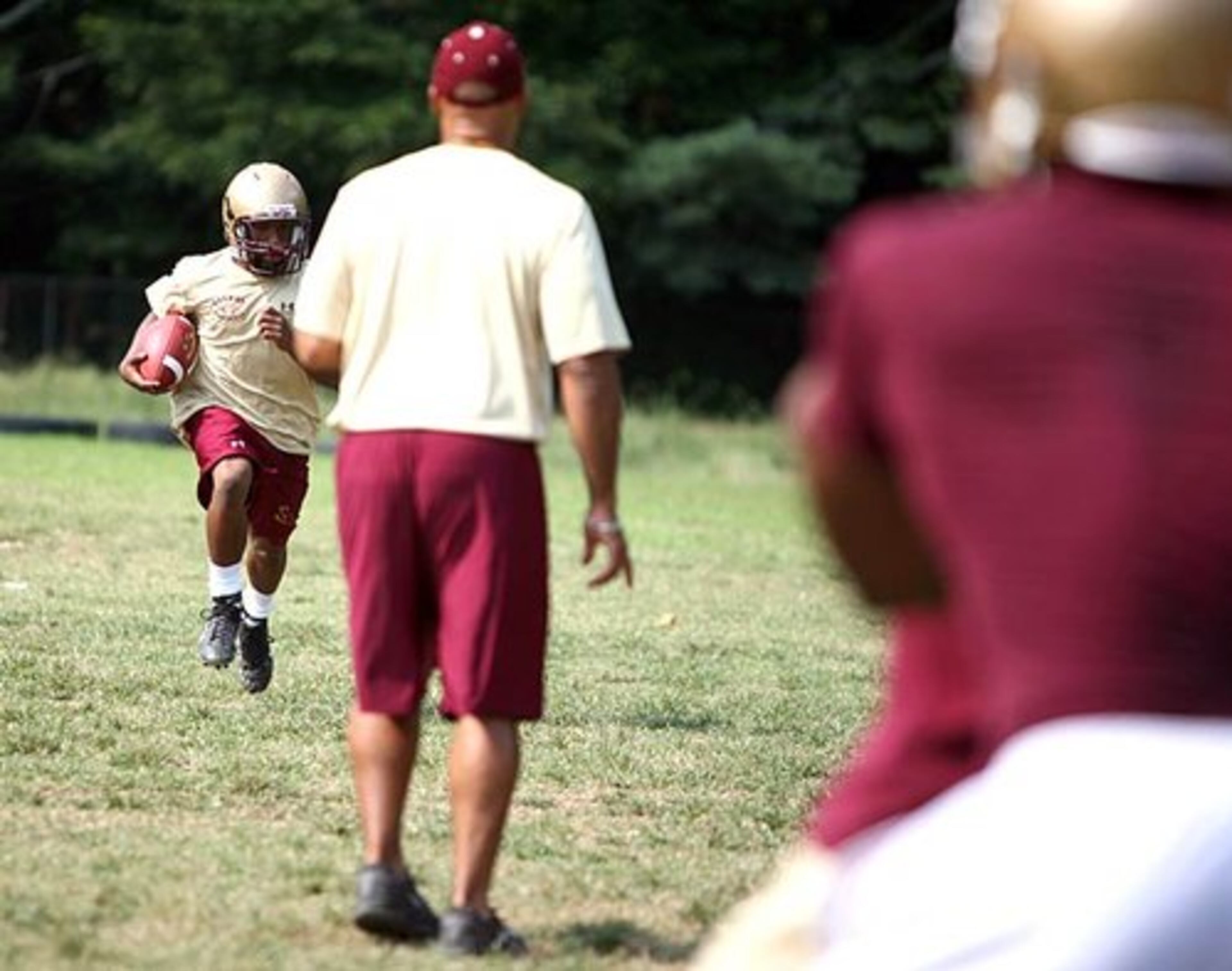 Devin Scott returns the ball during special teams practice under Franklin's ever-watchful eye. Scott brings explosive speed to the Tigers' roster.