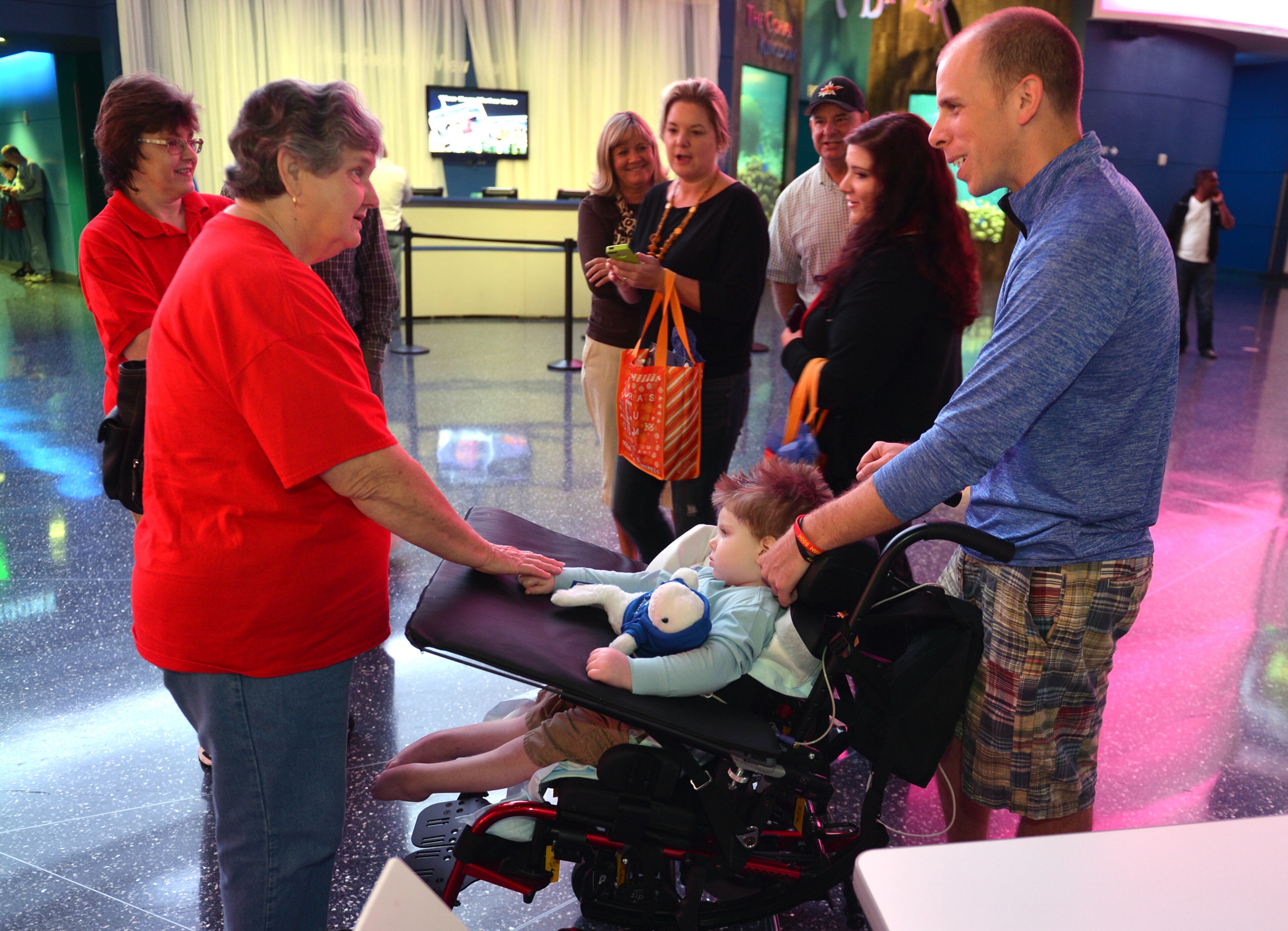 Pat May, who has been following Tripp Halstead's story on the news, came over to meet Tripp and his dad, Bill. Tripp and his family visited the Georgia Aquarium on the one-year anniversary of his suffering a brain injury.