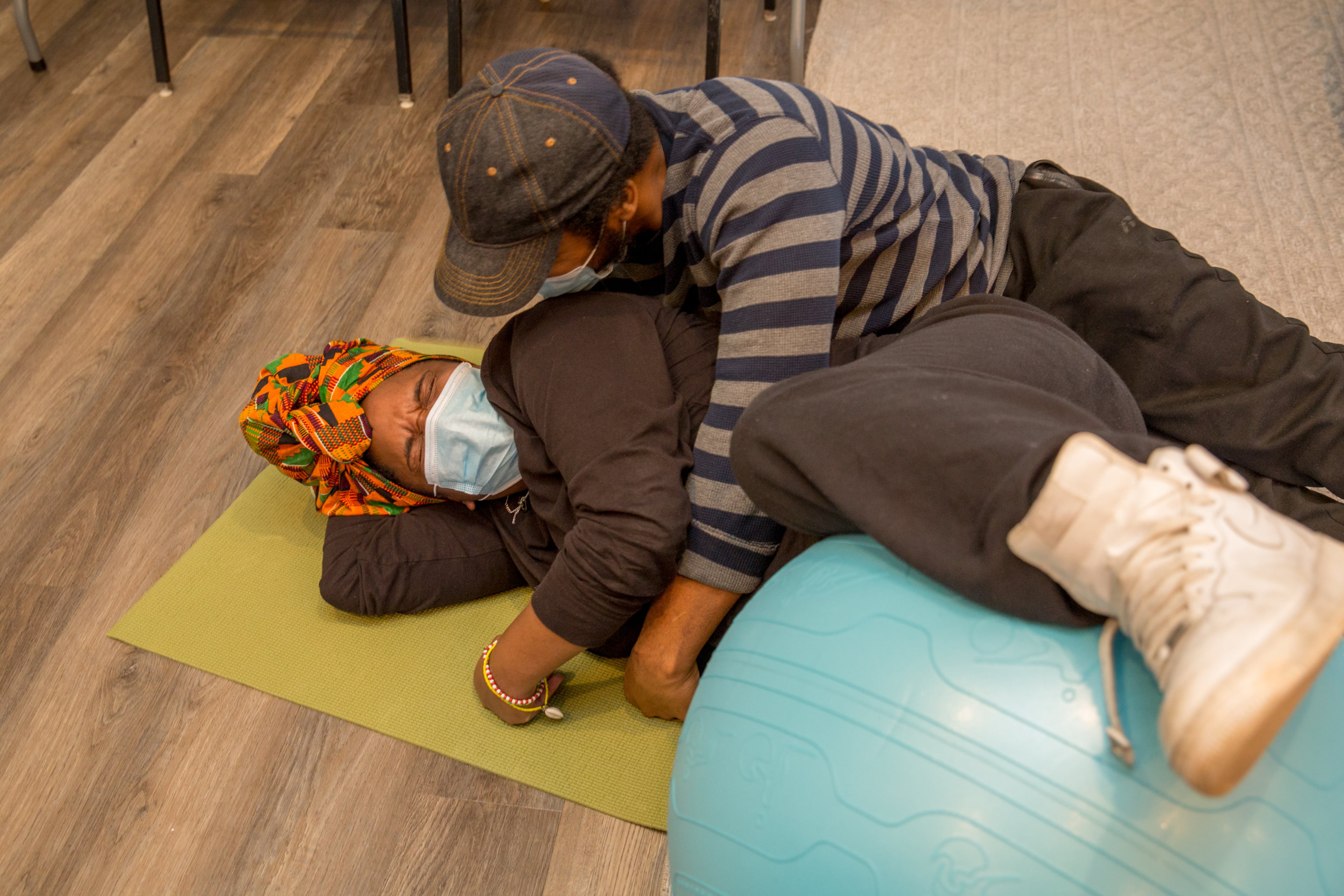 Lyric Behn and Devante Johnson practice a position and get a little silly at the Birth by Grace Midwifery class while working through options and positions for giving birth. (Jenni Girtman for The Atlanta Journal-Constitution)
