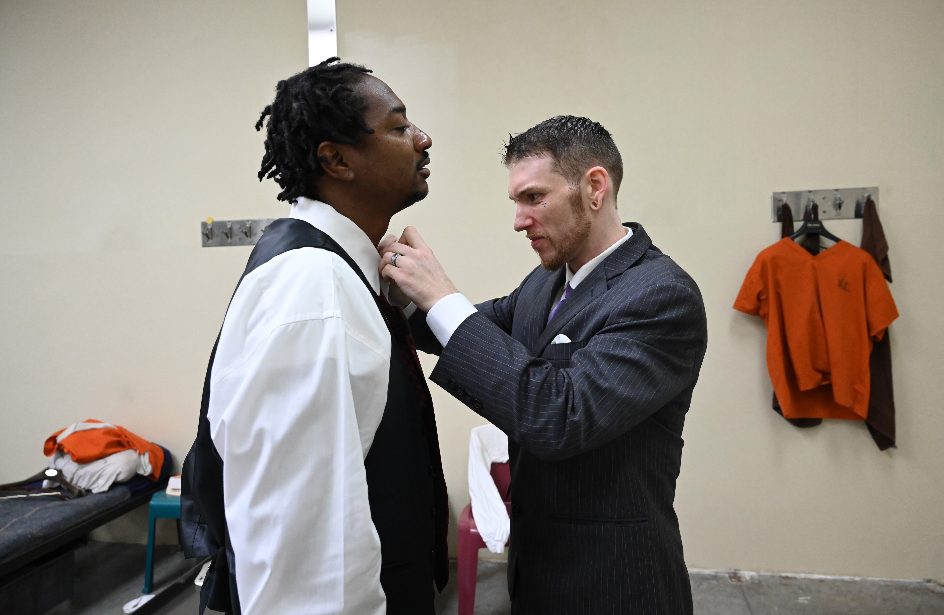 Cameron Stockton (right) helps Eldreco Craft with tying a necktie before their graduation ceremony for the Re-Entry Success Program at the Athens-Clarke County Jail on Wednesday, June 18, 2025, in Athens. (Hyosub Shin/AJC)