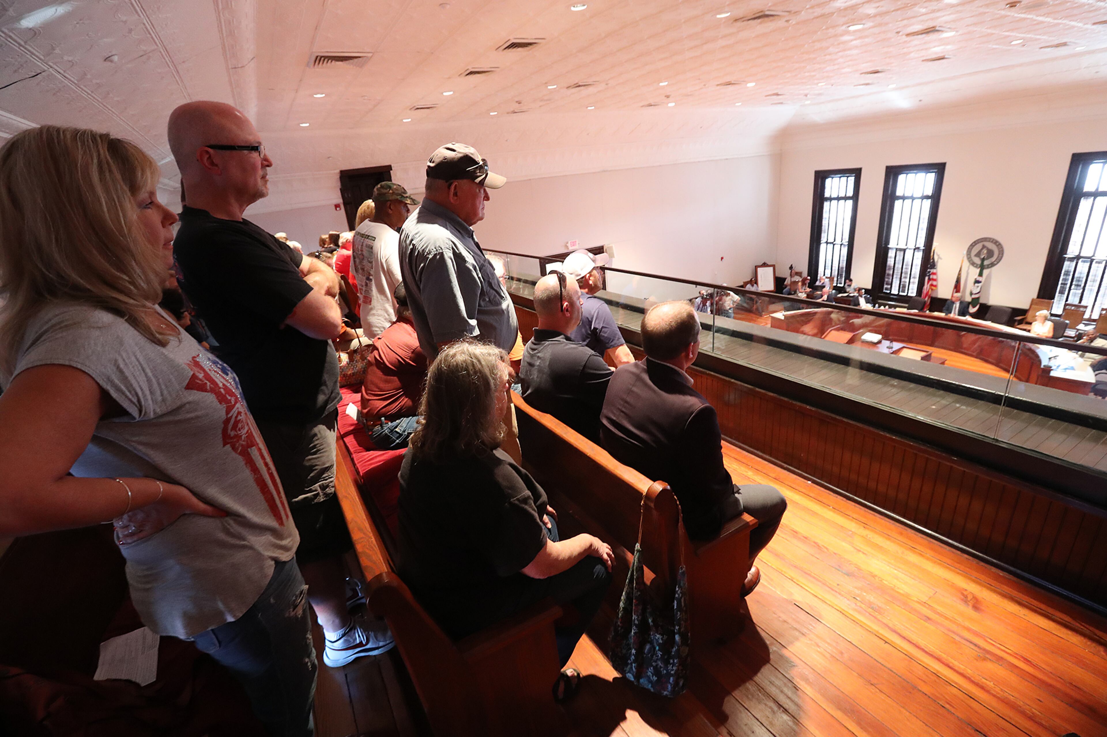 An overflow crowd listens from the balcony while hundreds more had to wait outside as Newton County held two town hall meetings to discuss plans to build a mosque and cemetery in the county on Monday, August 22, 2016, in Covington. Curtis Compton /ccompton@ajc.com