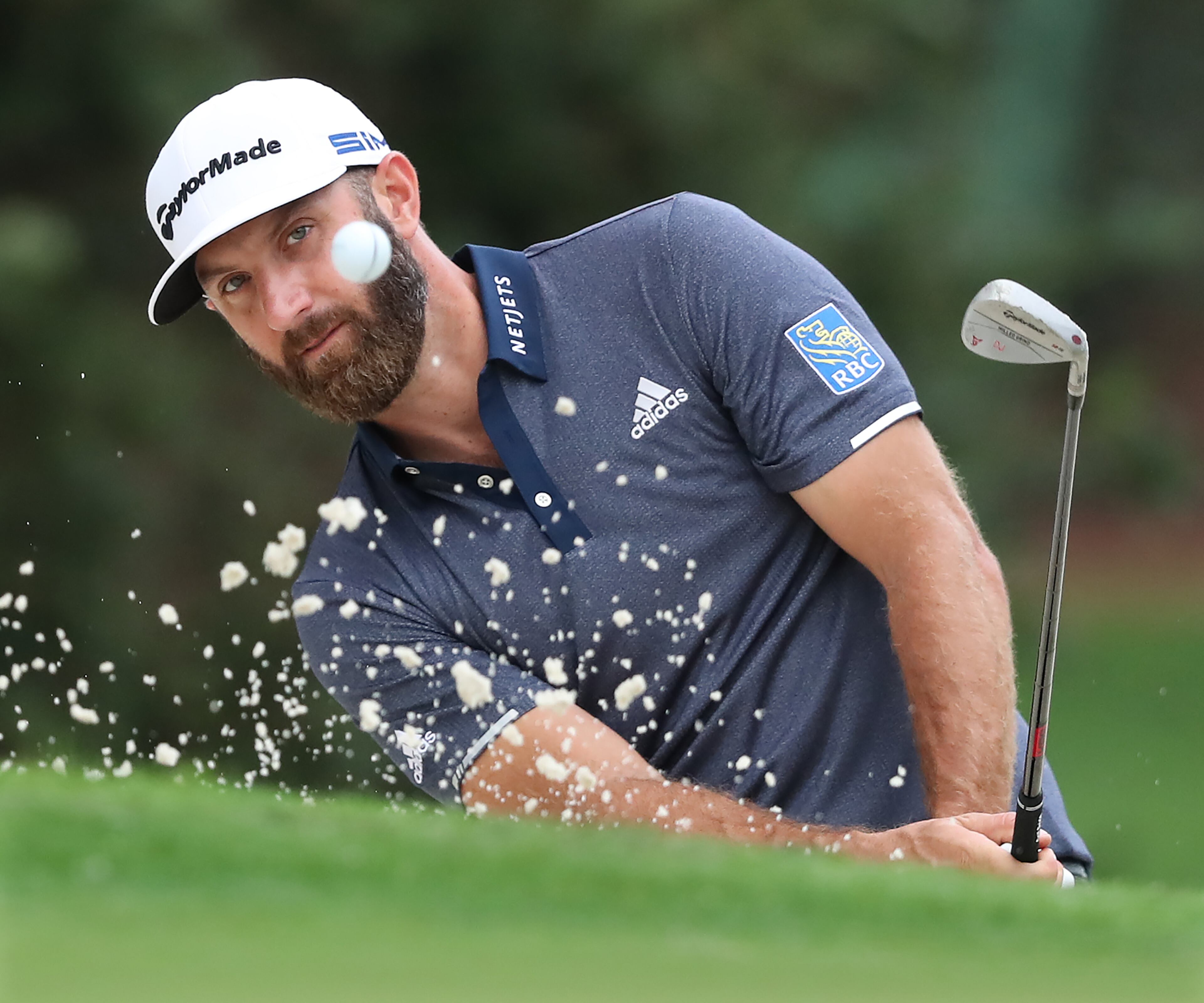 Dustin Johnson hits his sand shot to the 10th green during Tuesday's practice round at Augusta National.