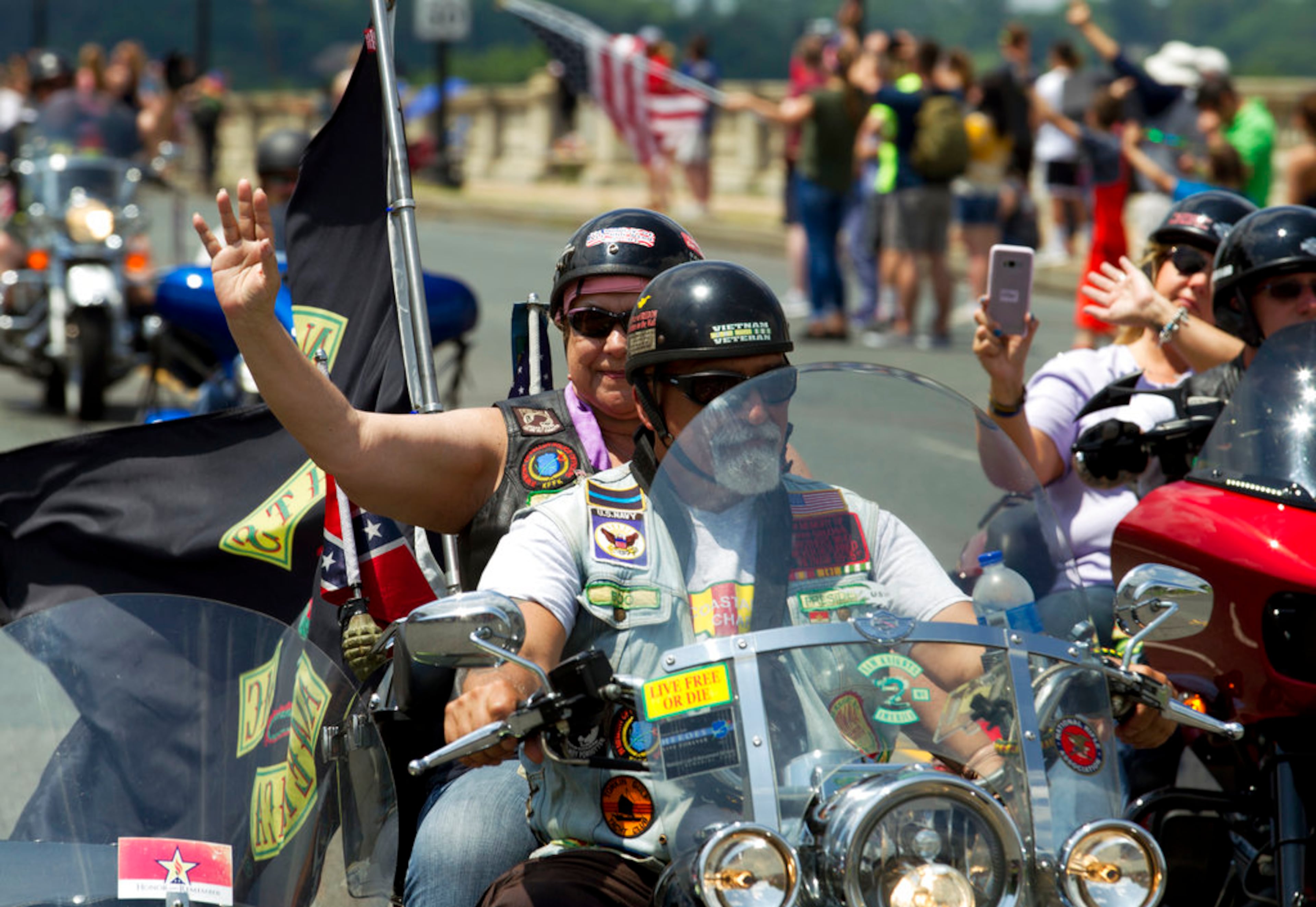 Participants in the Rolling Thunder motorcycle rally wave during the annual Rolling Thunder parade, ahead of Memorial Day, on Sunday, May 27, 2018, in Washington. (AP Photo/Jose Luis Magana)