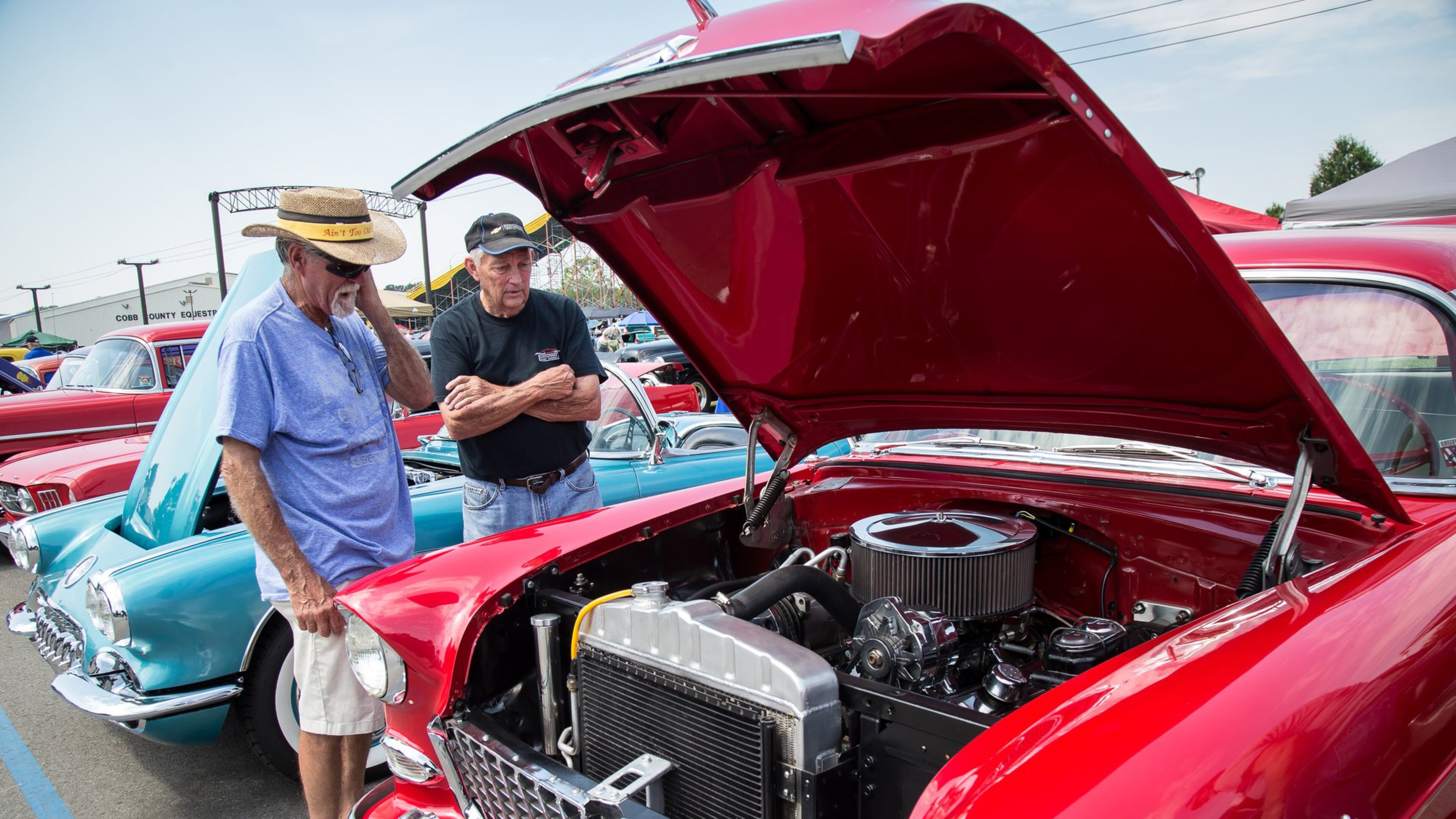 Larry Henson (L) and Fred Seagraves look over a 1955 Chevrolet during the 28th annual Creepers Car Show last year. STEVE SCHAEFER / SPECIAL TO THE AJC