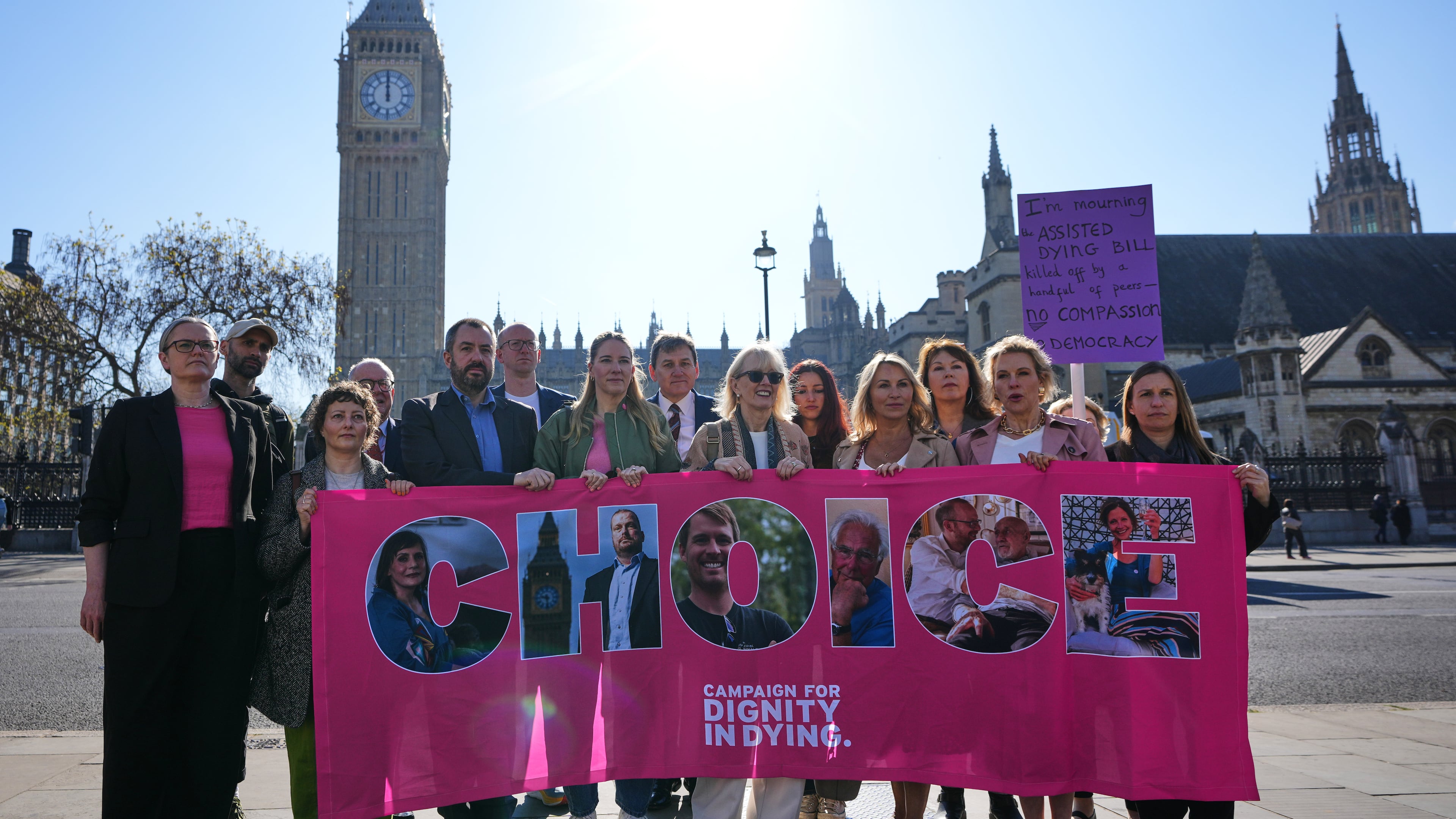 Campaigners hold a banner outside parliament in London as a proposed law to legalise assisted dying in England and Wales will run out of time on Friday, more than a year after MPs first voted in favour of it, Friday, April 24, 2026. (AP Photo/Kirsty Wigglesworth)