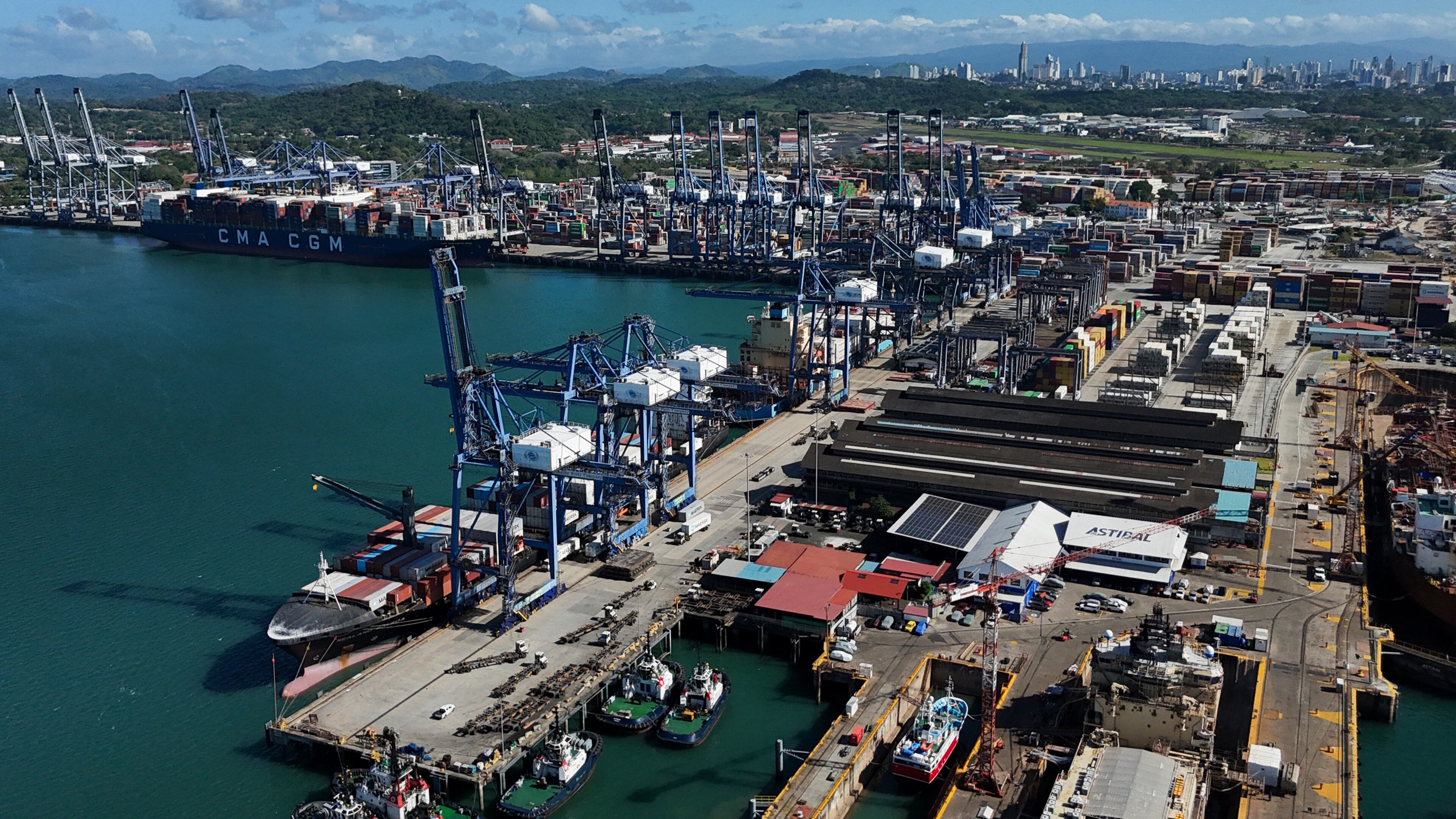 Cranes load a cargo ship at Panama Canal's Port of Balboa, managed by CK Hutchison Holdings, in Panama City, Friday, Jan. 30, 2026. (AP Photo/Matias Delacroix)