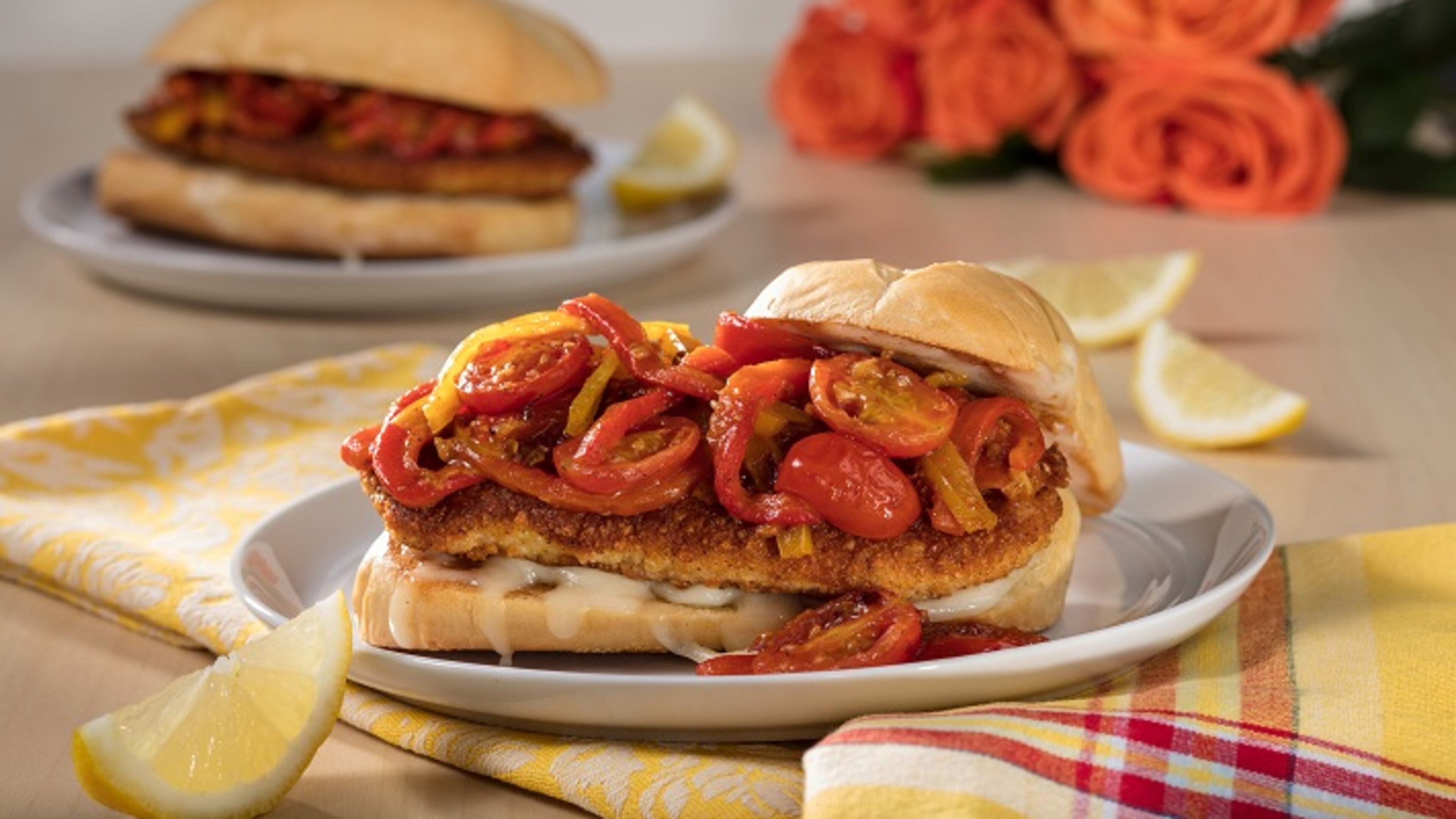 A saute of tomatoes, yellow bell peppers and cherry peppers bolsters the crisp breaded cutlet in this chicken Parmesan sandwich.
(Zbigniew Bzdak/Chicago Tribune/TNS)