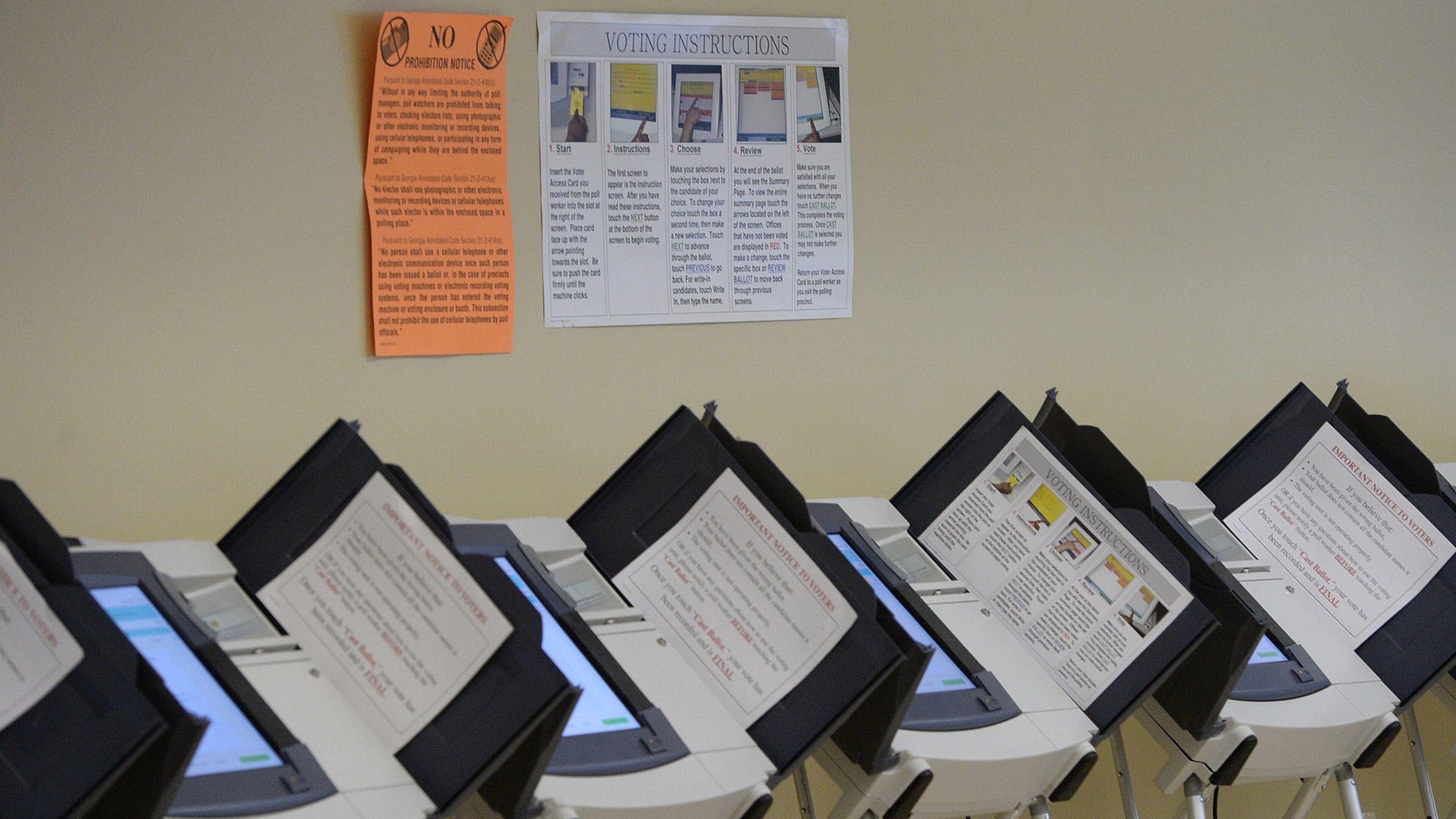 Empty voting machines line the wall inside the Fulton County Government Center in Atlanta on Tuesday, Oct. 22, 2013.