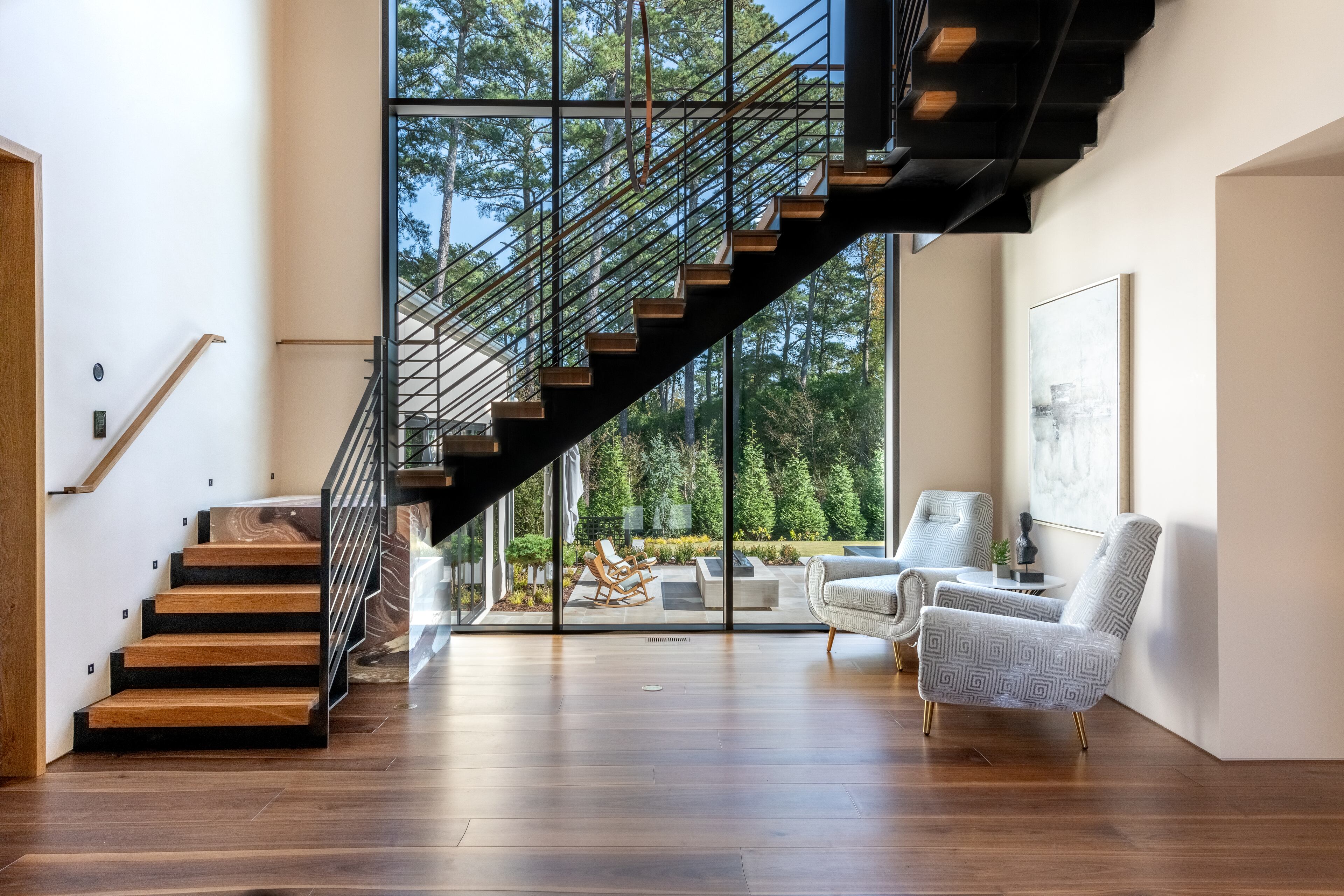 Huge windows allow for natural light to flow in by the staircase.