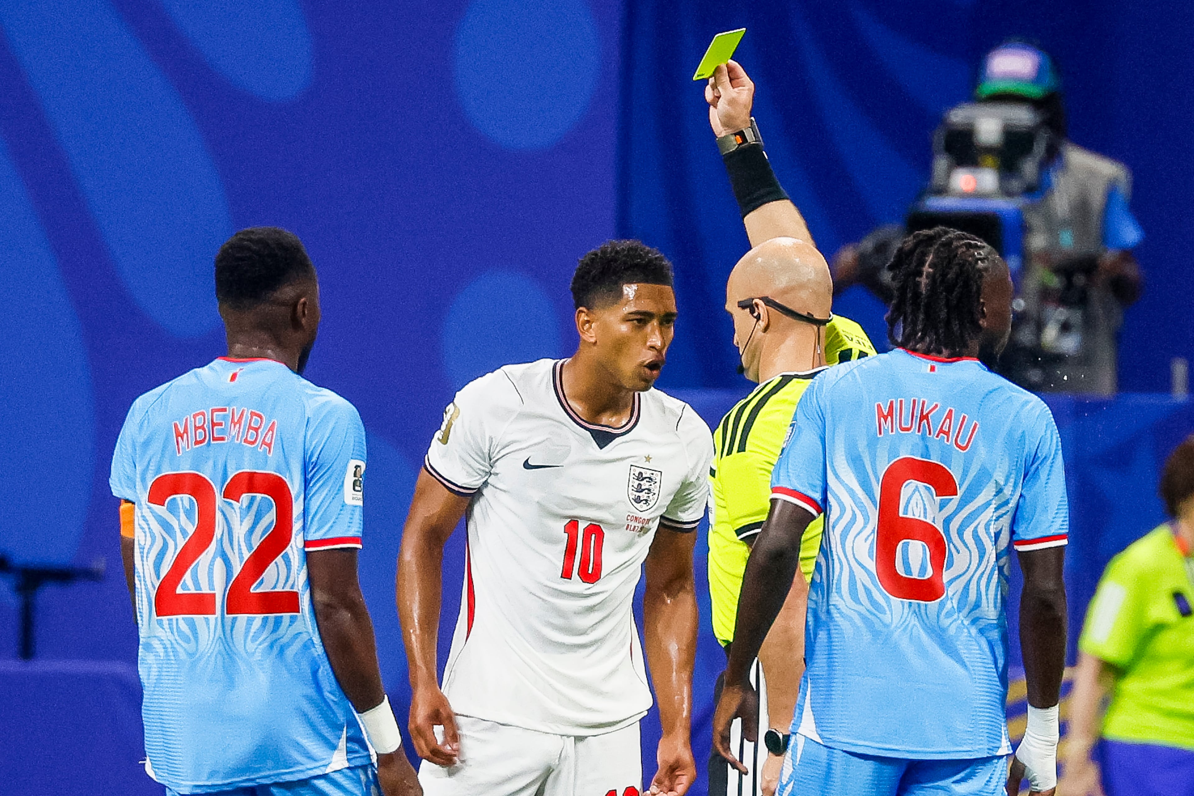 England midfielder Jude Bellingham (center) is called for a yellow card penalty during the first half of a FIFA World Cup round of 32 match as Congo defender Chancel Mbemba (left) and midfielder Ngal'ayel Mukau (right) look on at Atlanta Stadium (Mercedes-Benz Stadium) on Wednesday, July 1, 2026, in Atlanta. (Miguel Martinez/AJC)