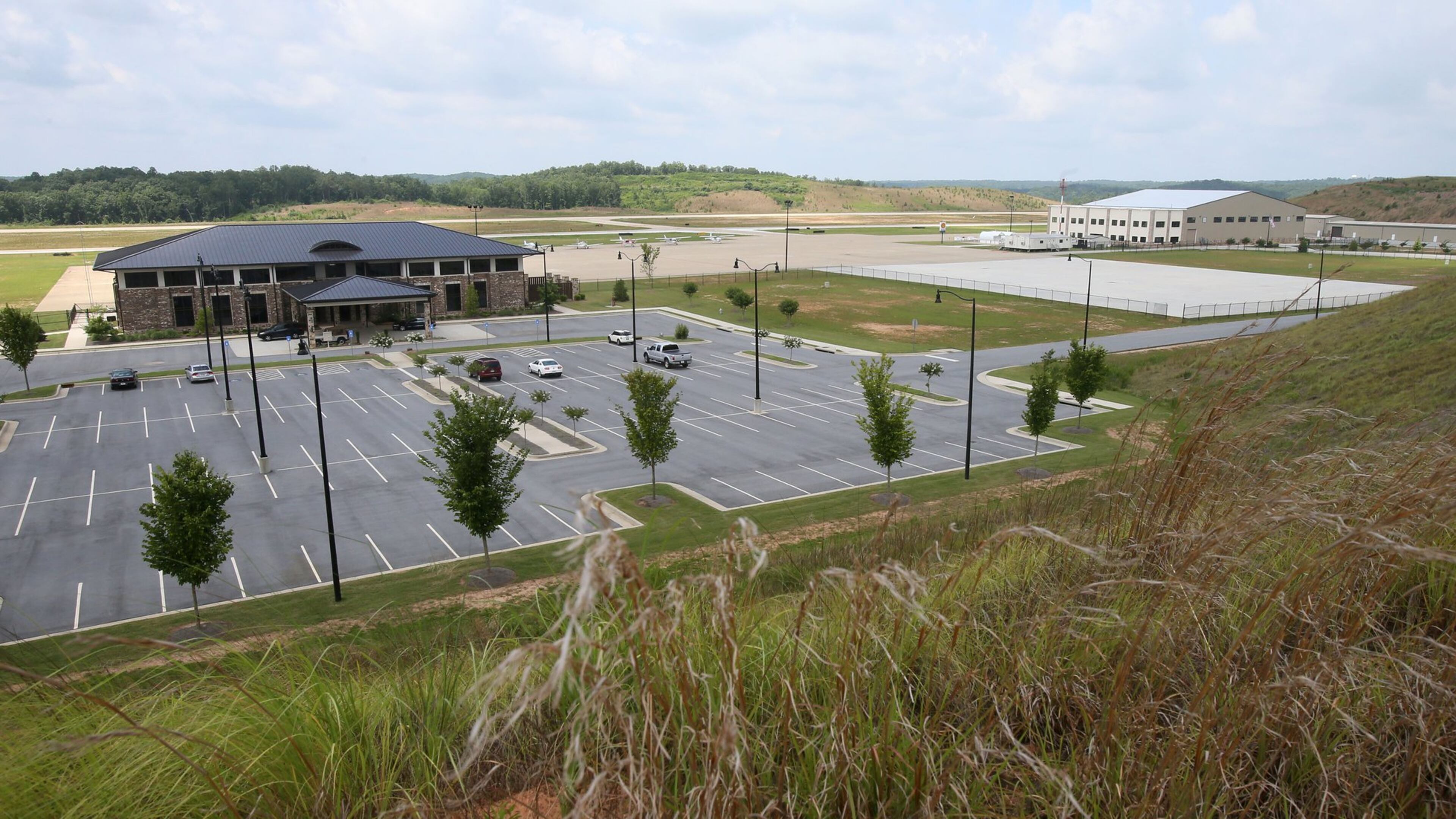June 25, 2014 - Paulding County - The Paulding County Airport terminal (left) and new hangers (right) viewed from a hill overlooking the airport. Taxi way expansion has been completed, and construction continues in FBO area of Paulding County Airport. First, Delta CEO Richard Anderson said he would fight Paulding County’s effort to commercialize its airport. Then residents filed four legal challenges. Now, the city of Atlanta is threatening legal action, saying Paulding, which purchased land from Atlanta for the airport back in 2007, is in breach of contract on that deal. Paulding officials deny that and say Atlanta’s opposition flies in the face of the regionalism that Mayor Kasim Reed spoke about to leaders there a few years ago. BOB ANDRES / BANDRES@AJC.COM