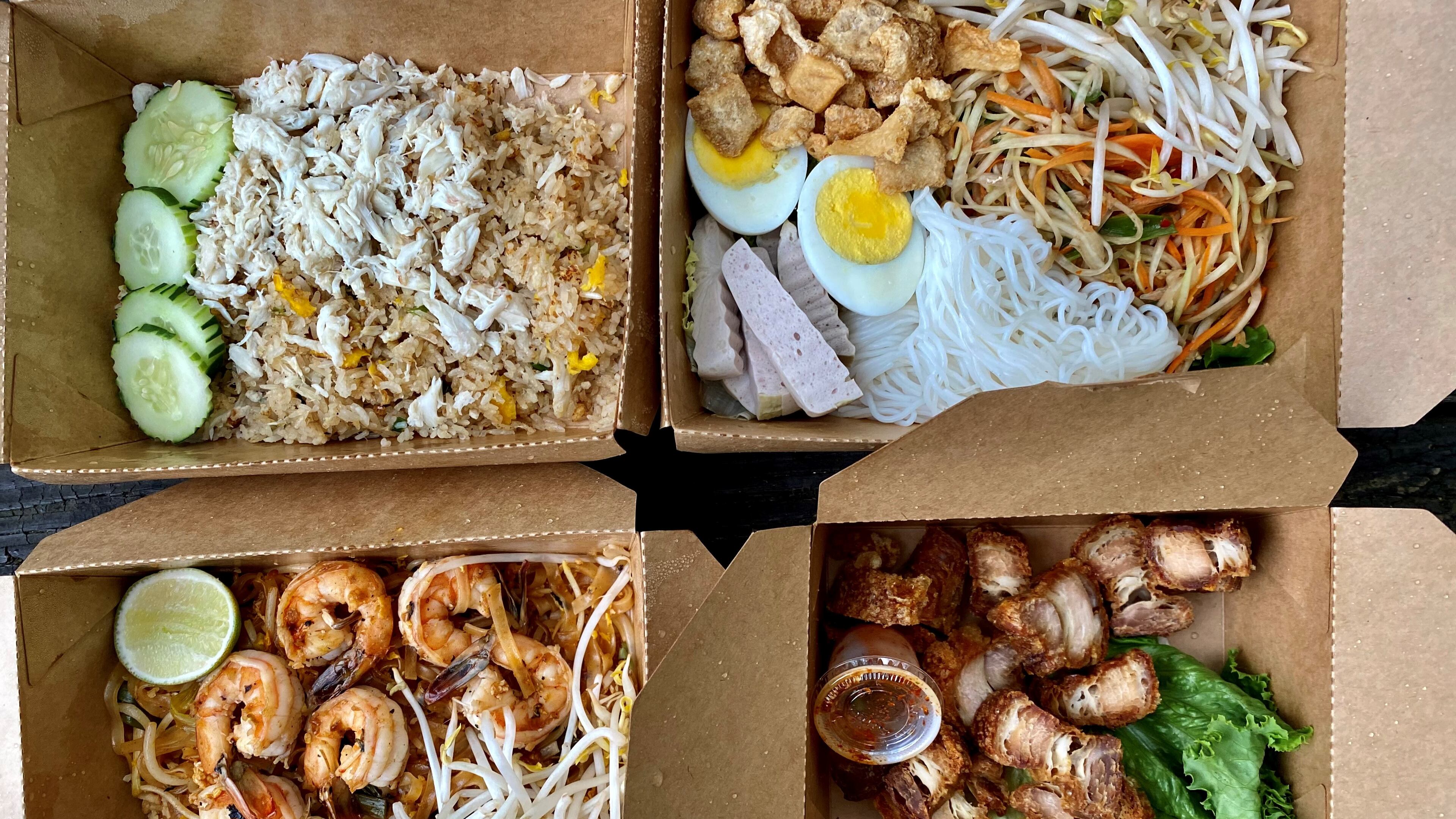 Takeout options from Tum Pok Pok include (clockwise from upper left): crab fried rice; som tum tard (Isan sausage, green papaya salad, and other nibbles); crispy fried pork belly; and pad Thai with shrimp. Wendell Brock for The Atlanta Journal-Constitution