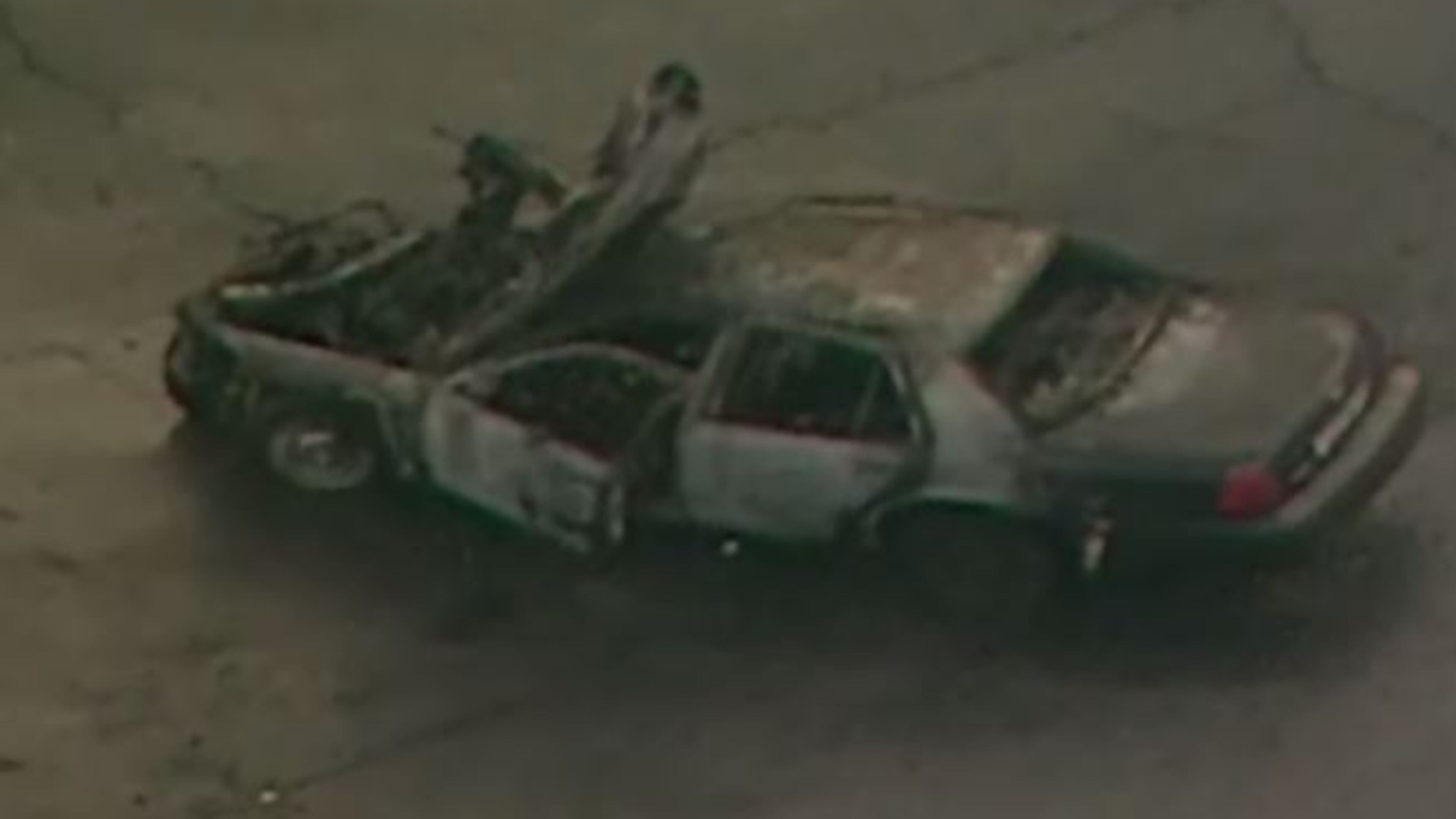 A charred Cobb County police car was cleared from the roadway after a crash in Fulton County Tuesday. The officer who was driving was seriously injured. (Credit: Channel 2 Action News)