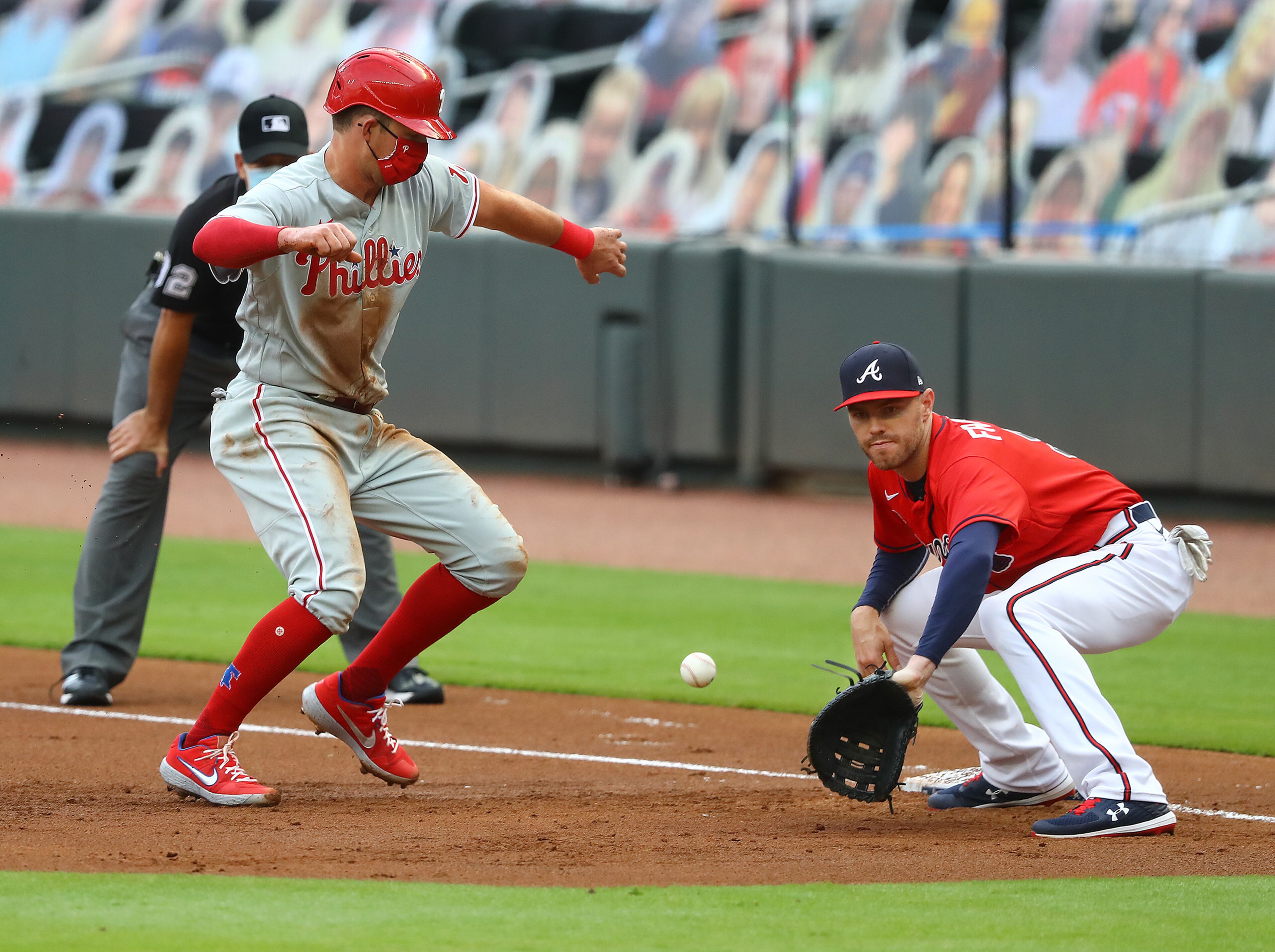 Atlanta Braves first baseman Freddie Freeman takes the pick off attempt from pitcher Josh Tomlin as Philadelphia Phillies Rhys Hoskins gets back just in time during the firs tinning in a MLB baseball game on Sunday, August 23, 2020 in Atlanta. Curtis Compton ccompton@ajc.com