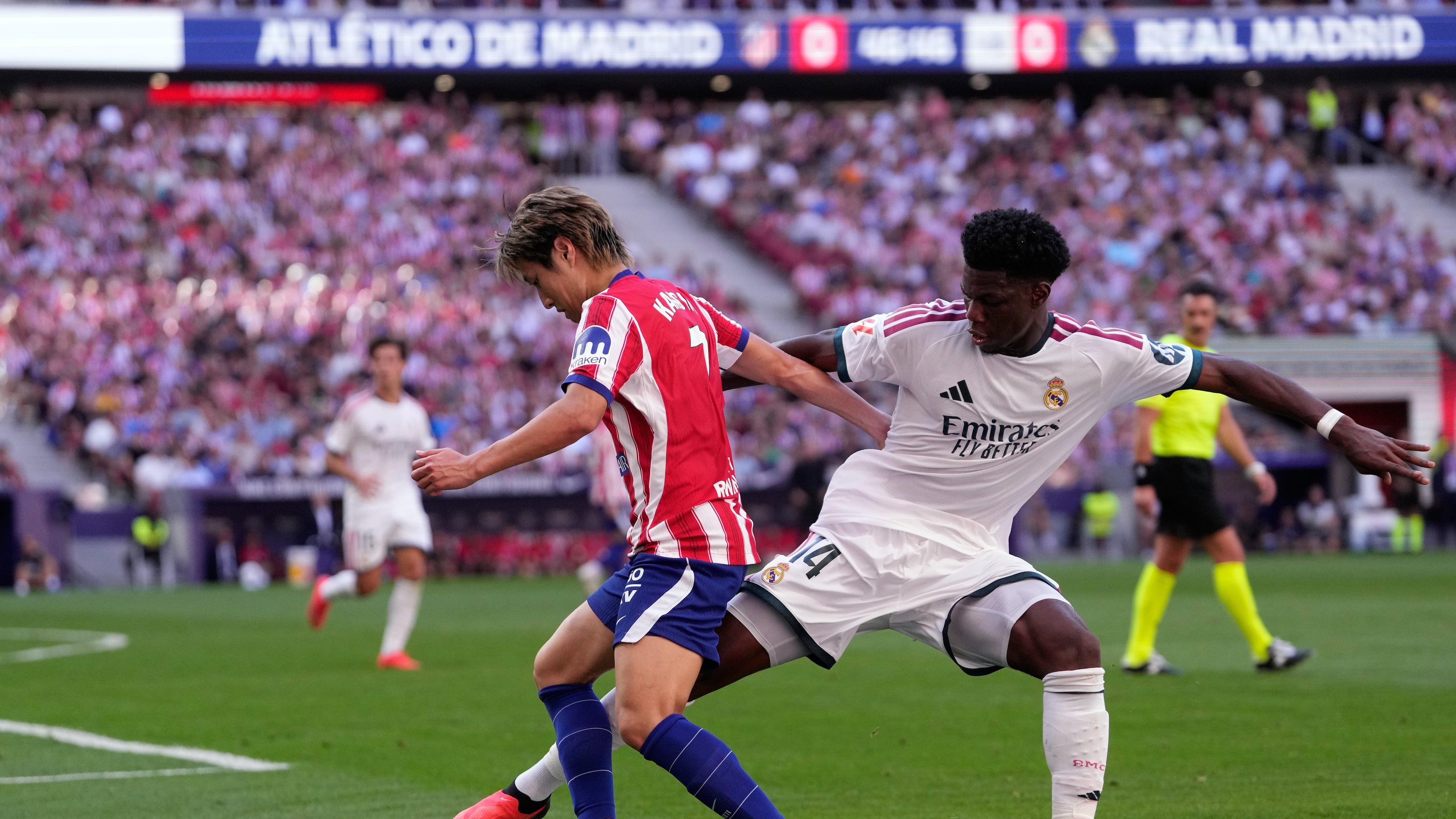 Atletico Madrid's Lee Kang-in tries to dribble the ball past Real Madrid's Aurelien Tchouameni, right, during a Spanish La Liga soccer match between Atletico Madrid and Real Madrid in Madrid, Sunday, Sept. 20, 2026. (AP Photo/Bernat Armangue)