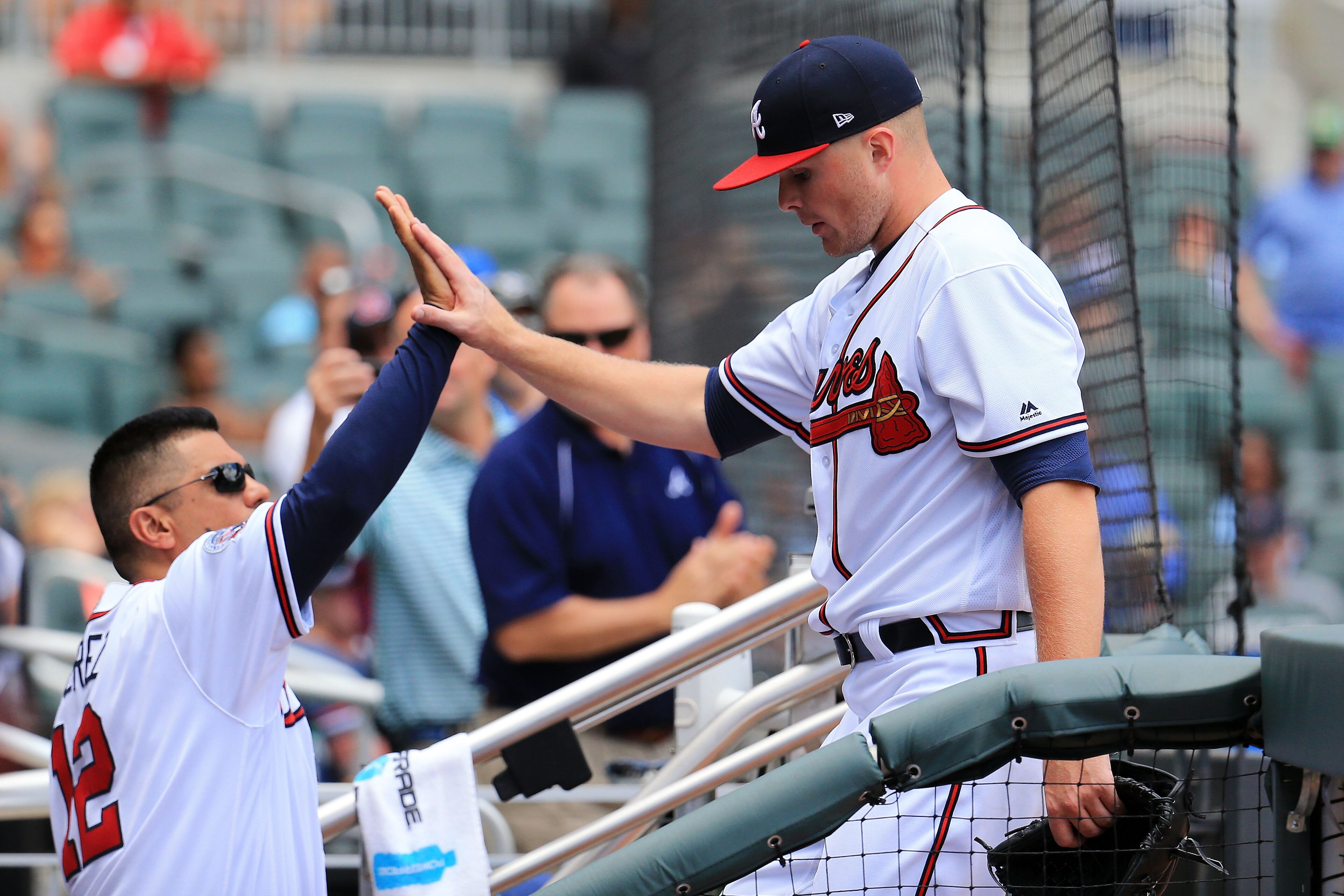 Sean Newcomb is greeted by Braves first base coach Eddie Perez after exiting the game in the top of the seventh.