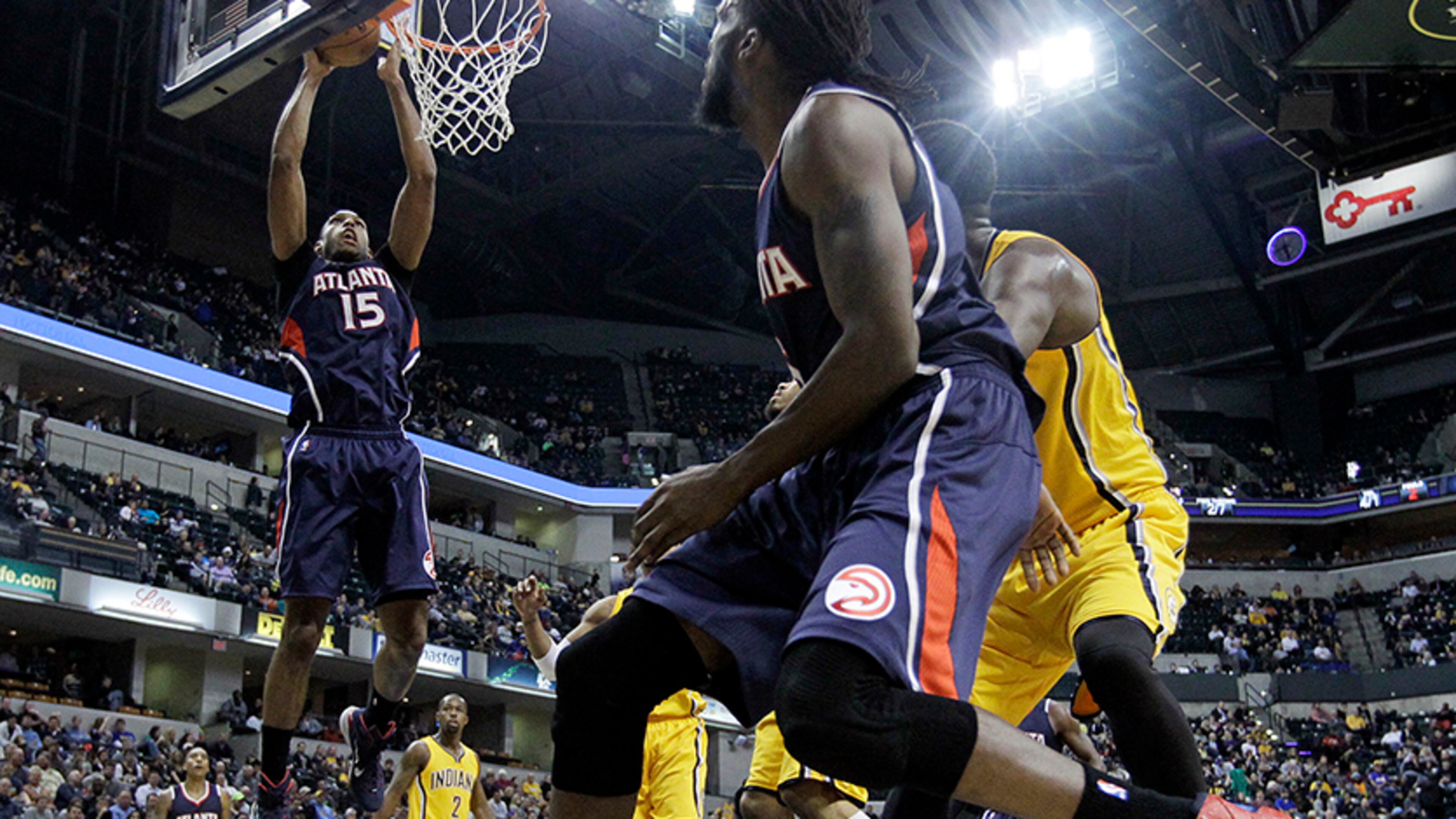 Atlanta Hawks' Al Horford (15) puts up a shot after taking a pass from DeMarre Carroll (foreground) during the second half of an NBA basketball game against the Indiana Pacers, Monday, Dec. 8, 2014, in Indianapolis. Atlanta won 108-92.
