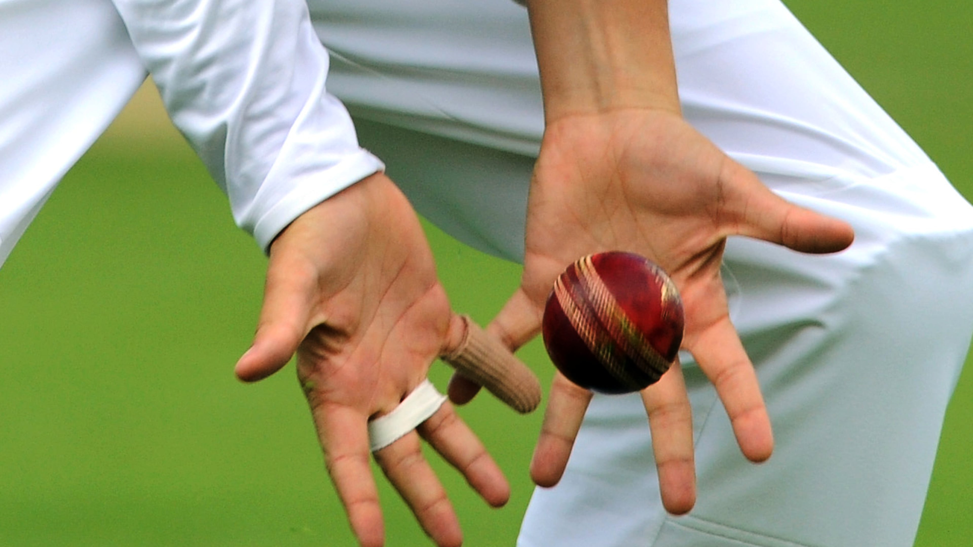 FILE - View of cricketer's hands catching a cricket ball during day four of the first Ashes Test cricket match, in Cardiff, Wales, Saturday, July 11, 2015. (AP Photo/Rui Vieira, file)