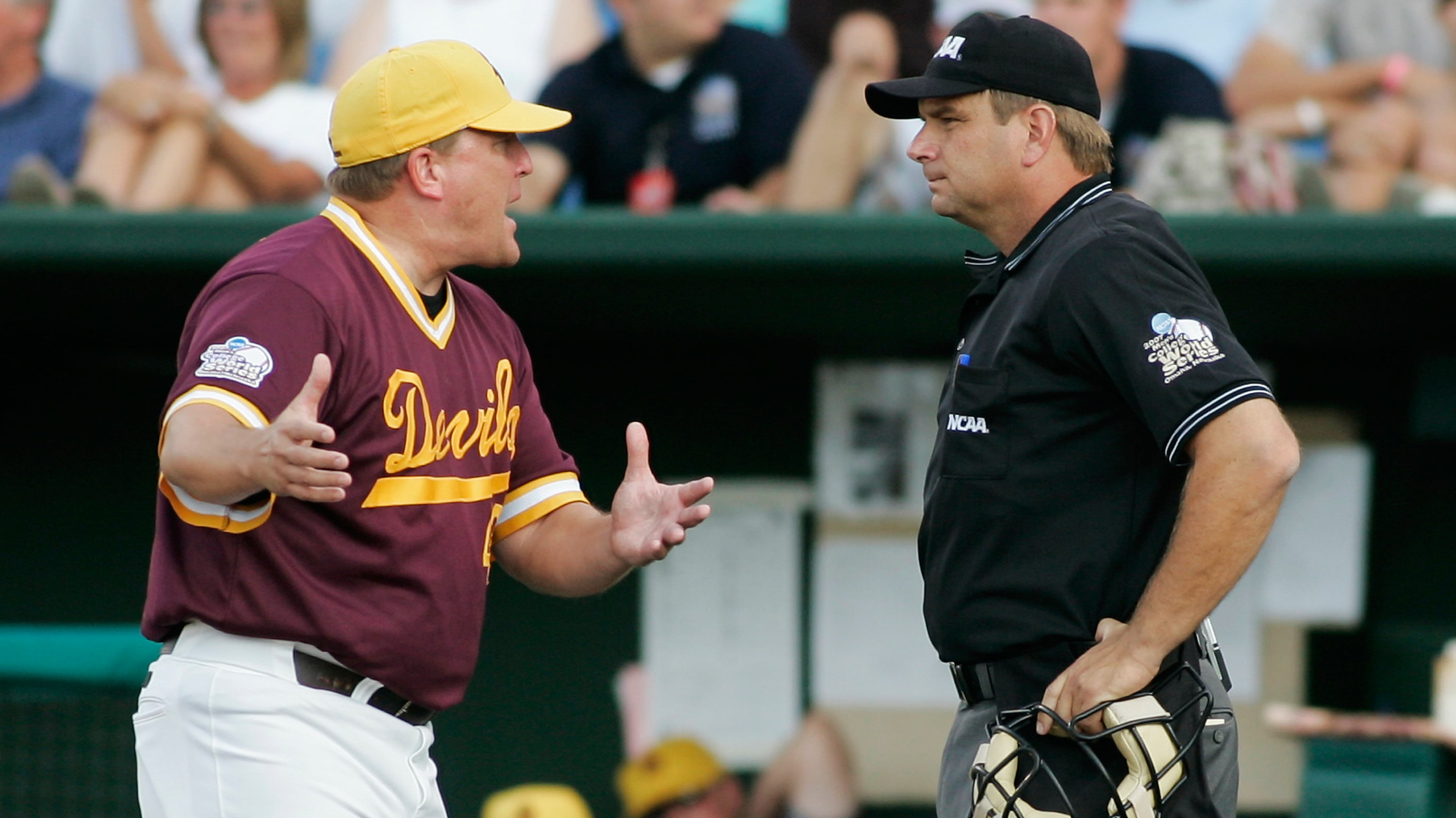 FILE - Arizona State coach Pat Murphy, left, protests to home plate umpire Jeff Henrichs after a balk call allowed UC Irvine's Taylor Holiday to score in the fourth inning of a College World Series baseball elimination game in Omaha, Neb., June 19, 2007. (AP Photo/Eric Francis, File)