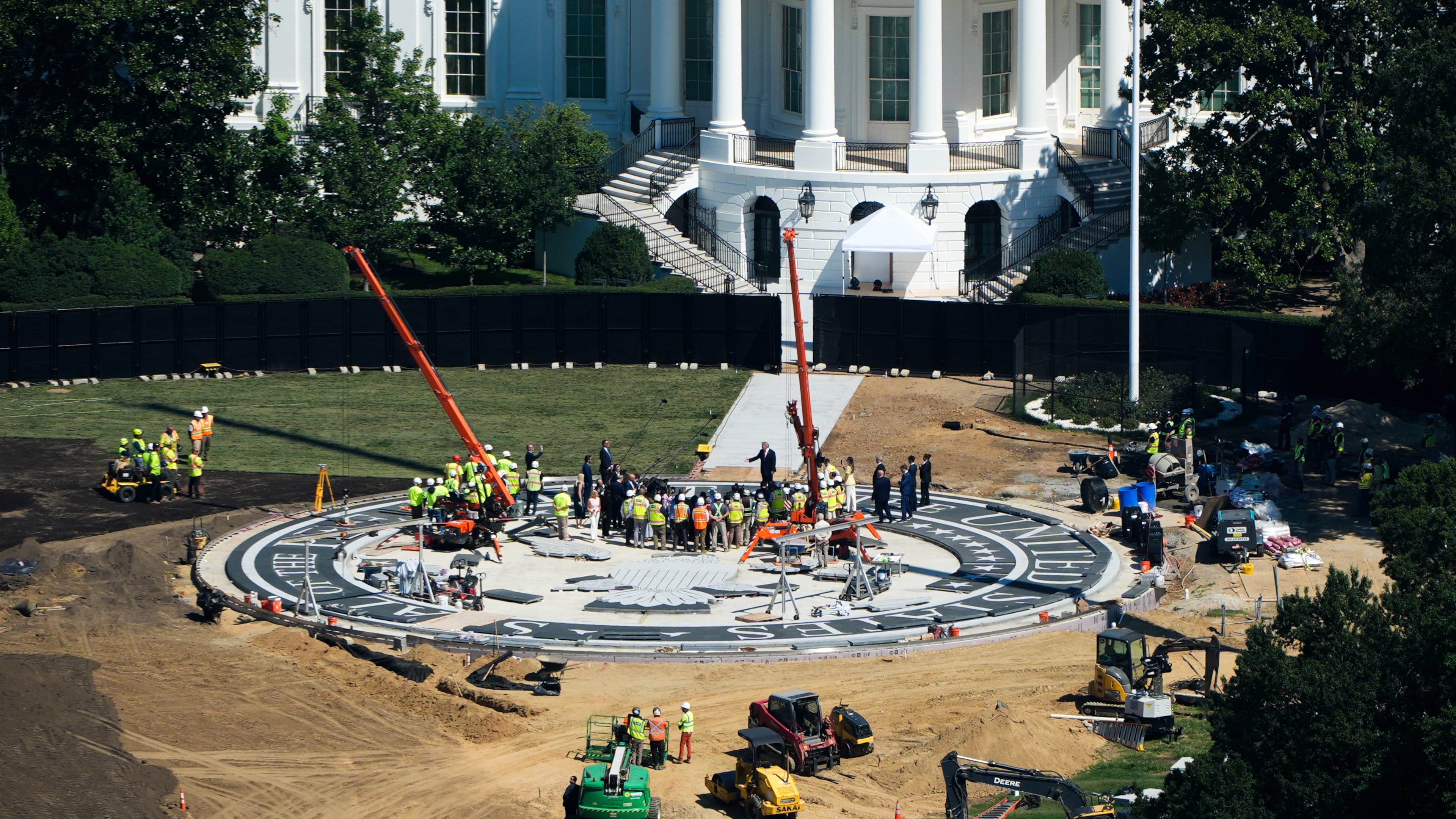 President Donald Trump speaks on the South Lawn of the White House at the construction site of the new helicopter landing zone, Wednesday, Aug. 19, 2026, seen from the Washington Monument in Washington. (AP Photo/Alex Brandon)