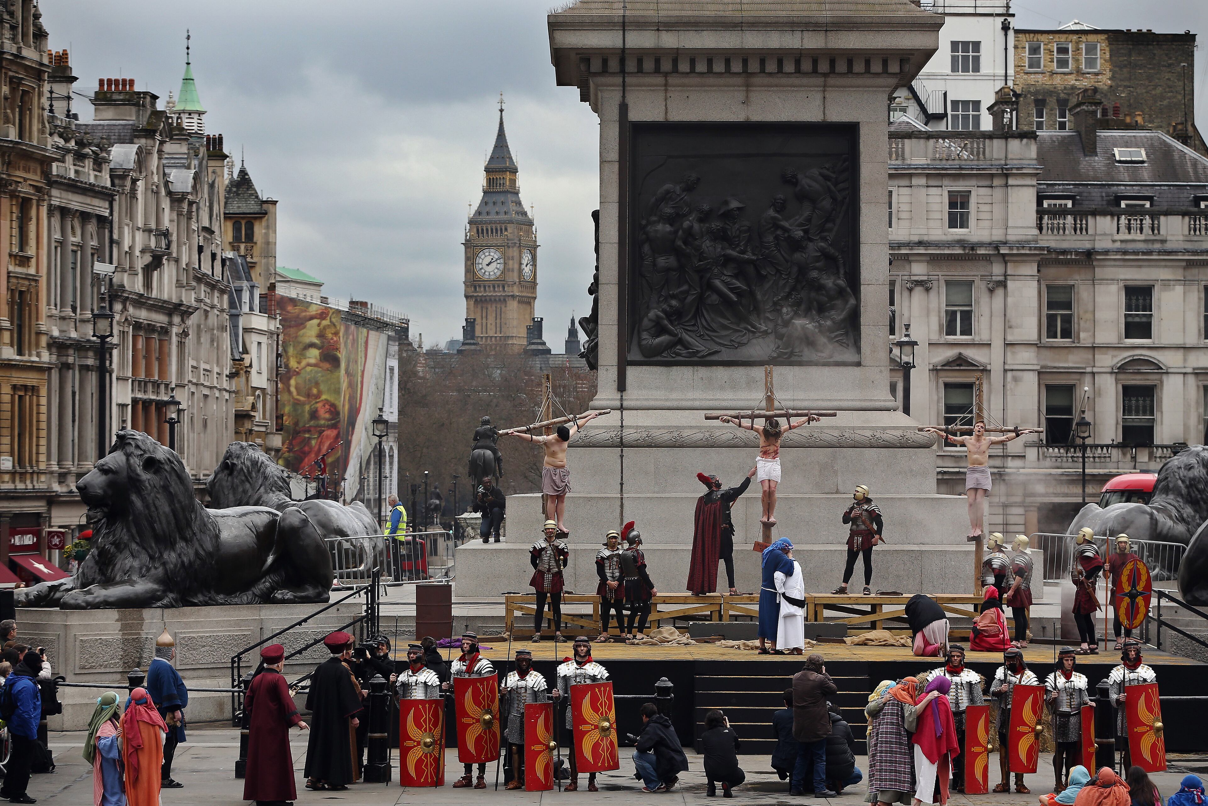 LONDON, ENGLAND - APRIL 03: Actor James Burke-Dunsmore hangs on the cross as Jesus during the Wintershall's 'The Passion of Jesus' production on Good Friday in Trafalgar Square on April 3, 2015 in London, England. Good Friday is a Christian religious holiday before Easter Sunday, which commemorates the crucifixion of Jesus Christ on the cross. The Wintershall's theatrical production of 'The Passion of Jesus' includes a cast of 100 actors, horses, a donkey and authentic costumes of Roman soldiers in the 12th Legion of the Roman Army. (Photo by Dan Kitwood/Getty Images)