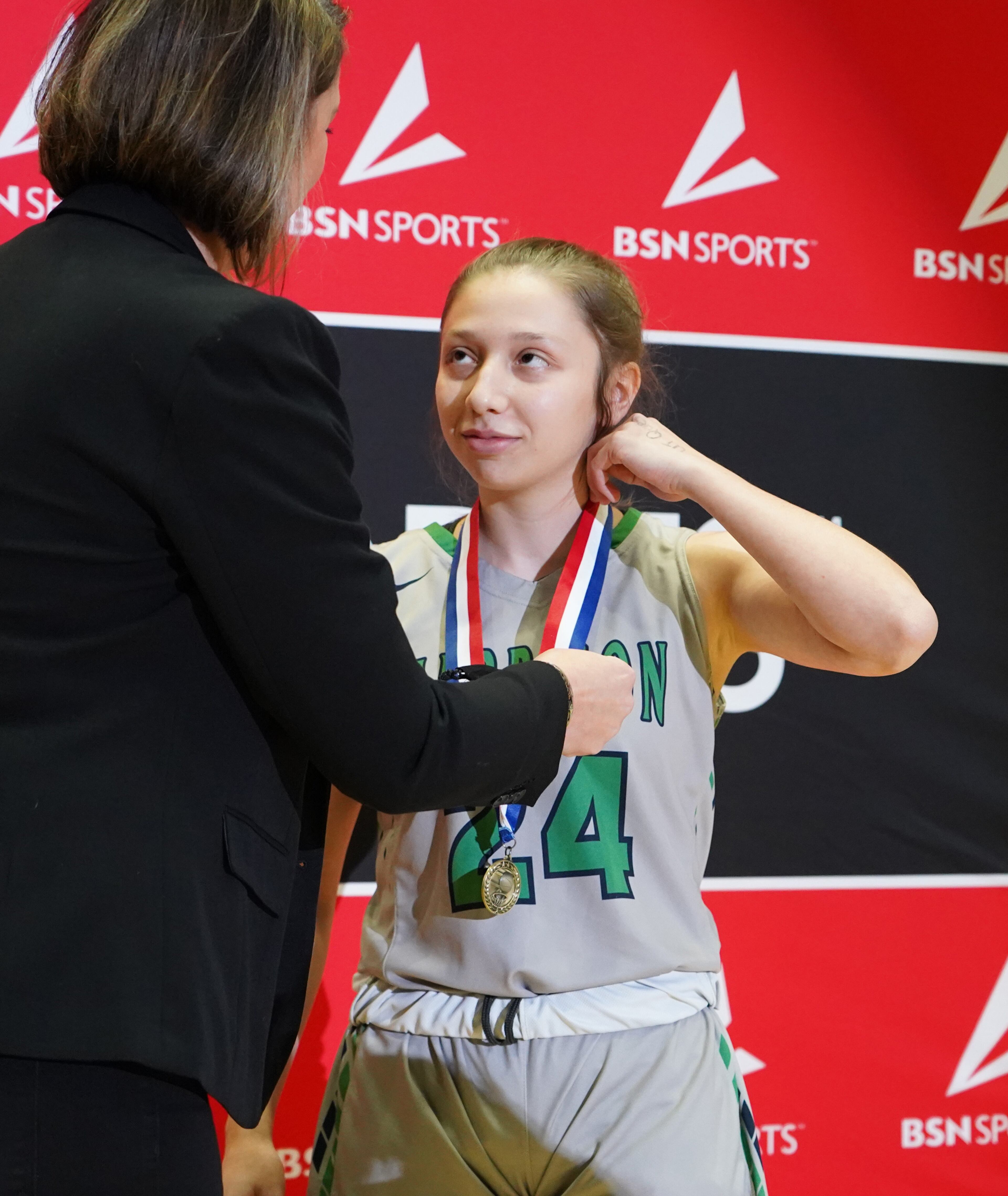 Harrison's Emily Acampora receives a medal for winning the three-point contest. Tami Chappell for the Atlanta Journal Constitution