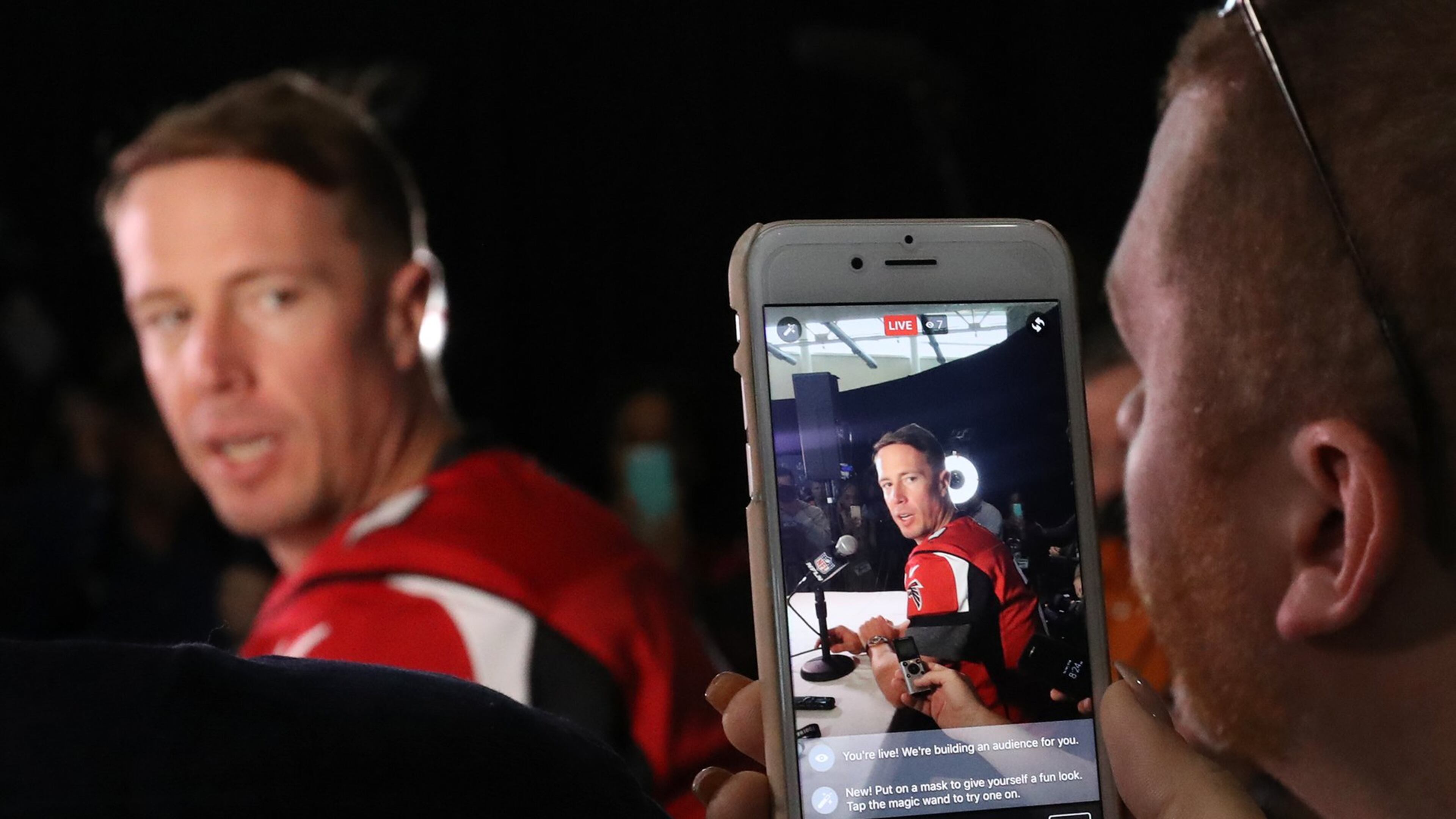 A reporter runs video while asking Falcons quarterback Matt Ryan a question during Super Bowl media availability at Memorial City Mall ice arena in Houston. (Curtis Compton/ccompton@ajc.com)
