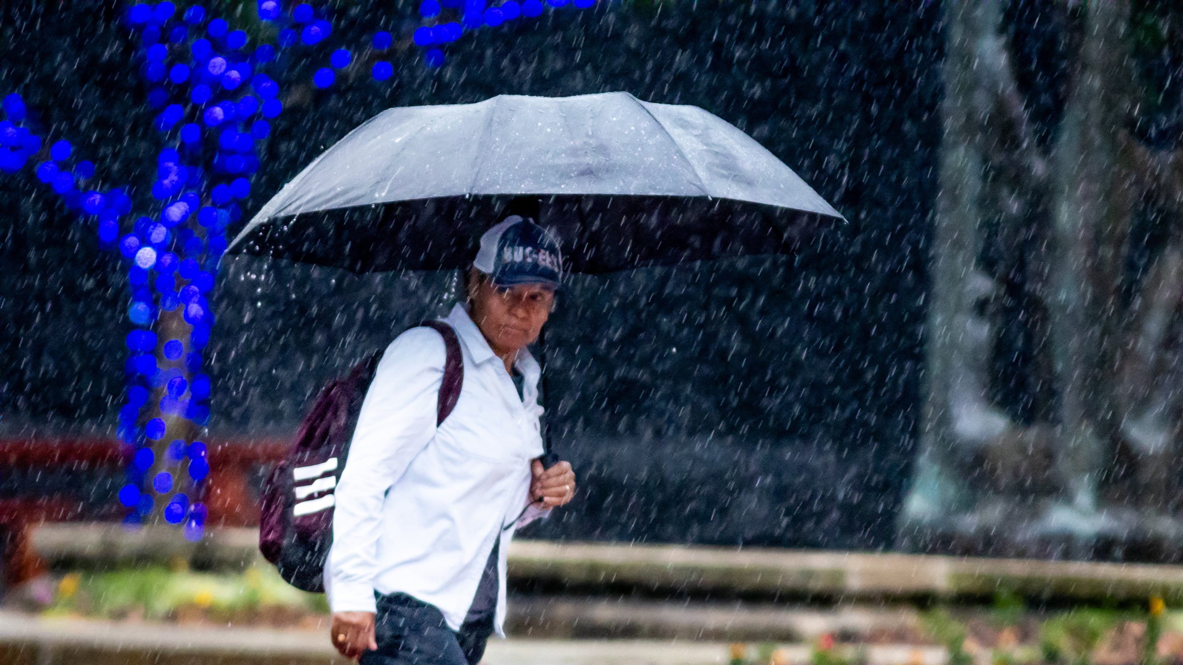 Braving a heavy downpour, this pedestrian, who declined to be identified, crossed Peachtree Street at 15th Street in Midtown Atlanta on Thursday.