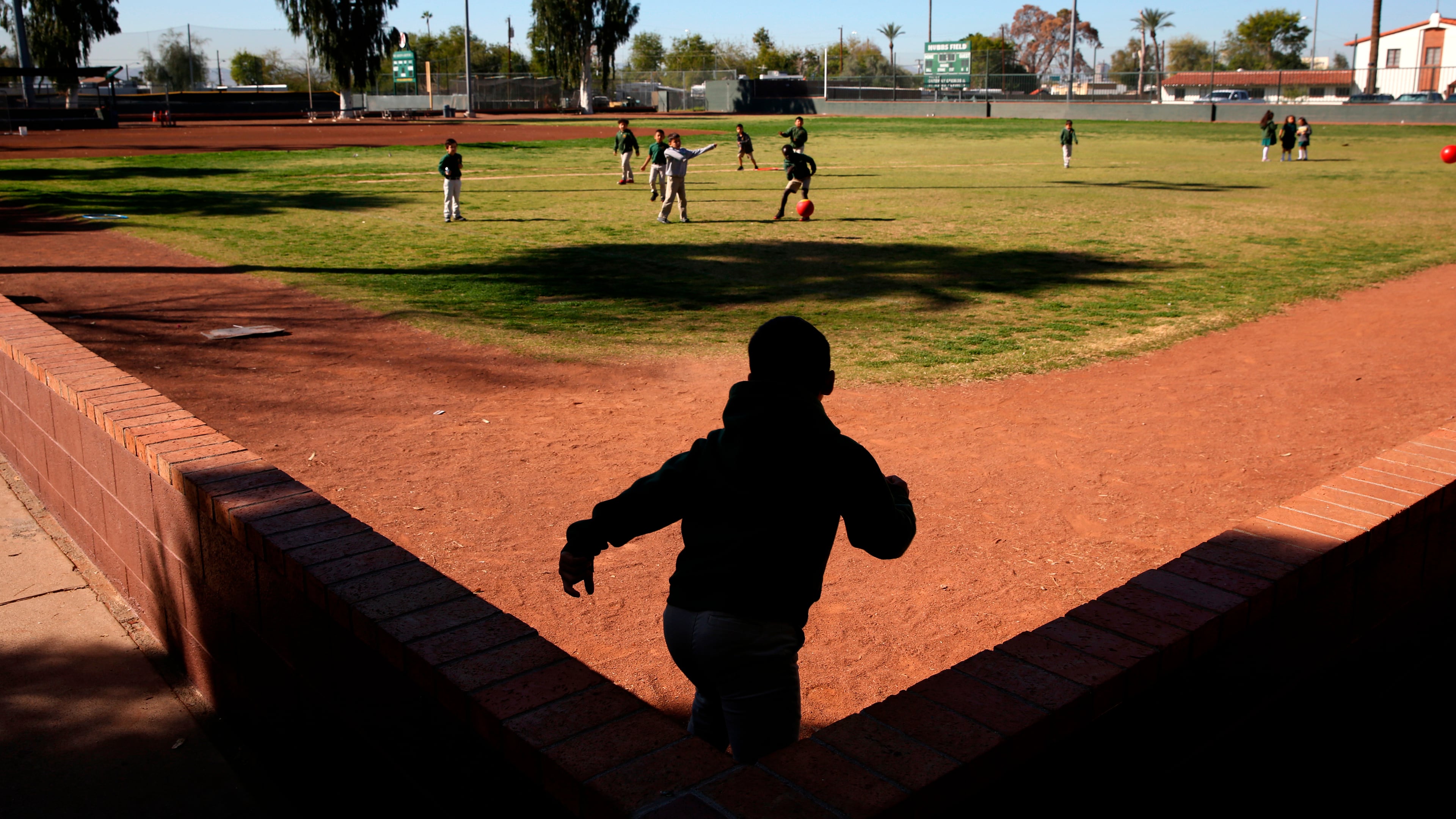 FILE- Students play ball during recess at the St. Agnes Elementary School in Phoenix, Ariz., on March 3, 2020. (AP Photo/Dario Lopez-MIlls, File)