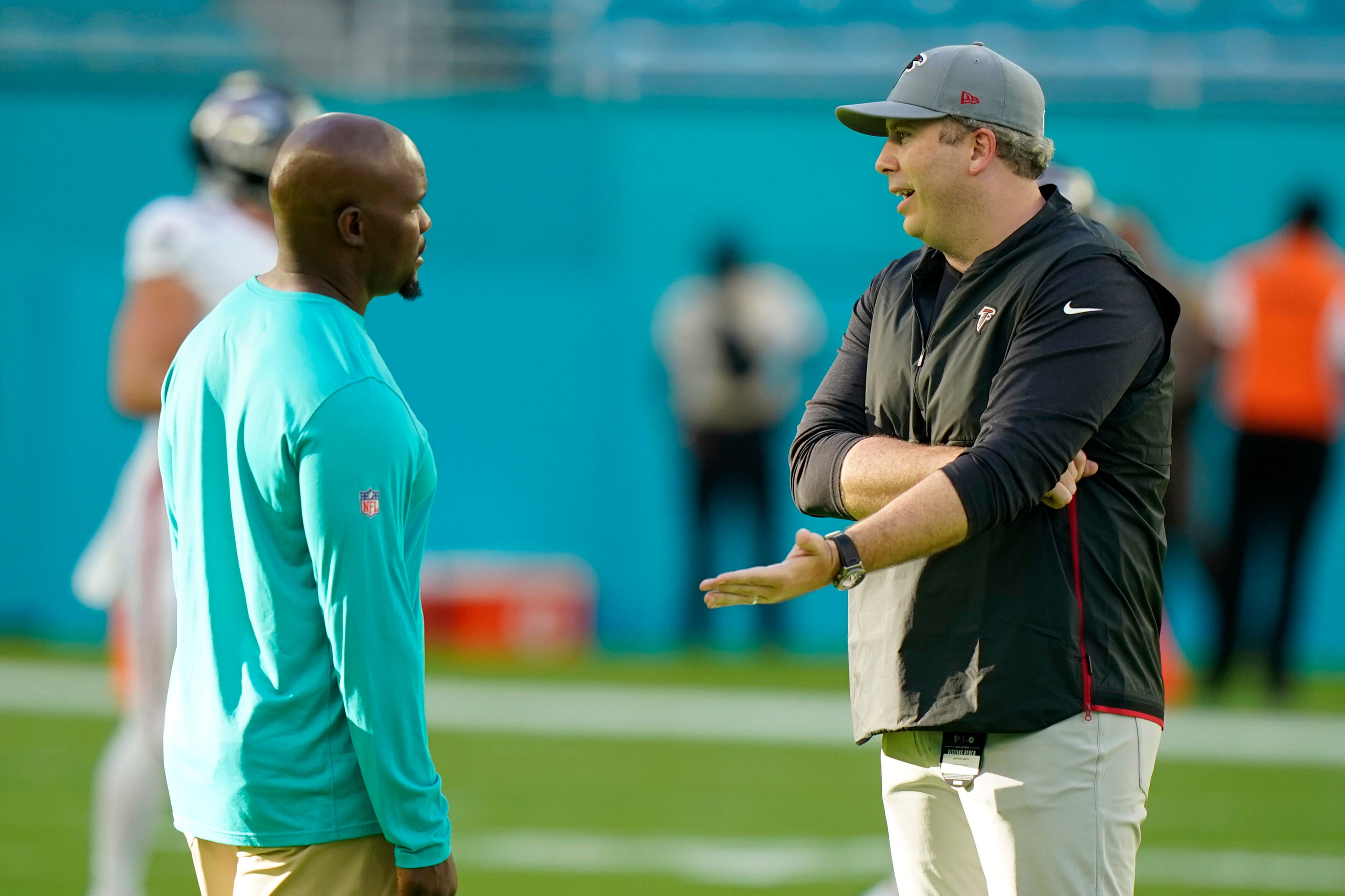 Miami Dolphins head coach Brian Flores, left, talks to Atlanta Falcons head coach Arthur Smith before a NFL preseason football game, Saturday, Aug. 21, 2021, in Miami Gardens, Fla. (AP Photo/Wilfredo Lee)