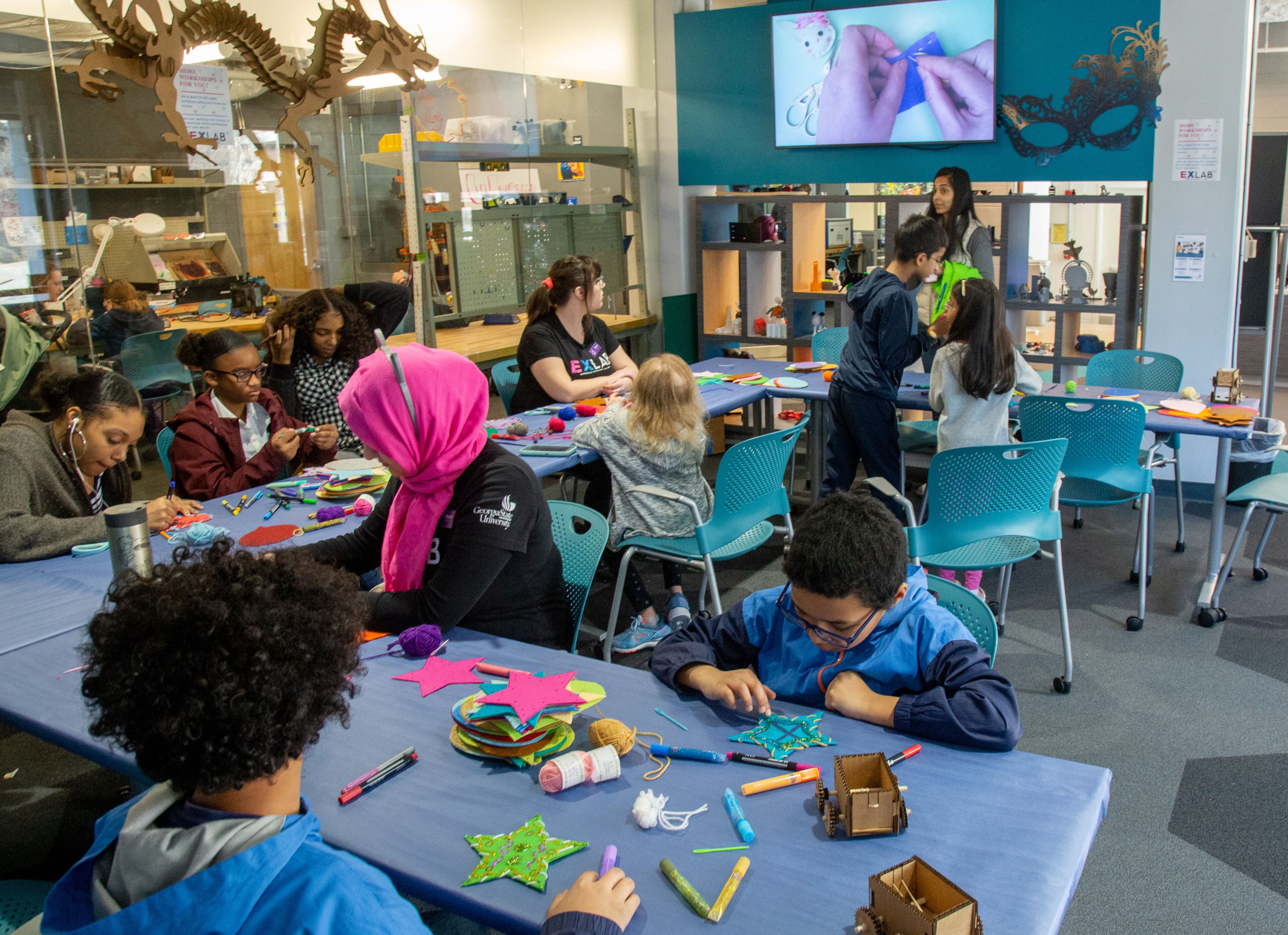 People work on their sewing projects during the Genius Camp in the ExLab at Georgia State University on Saturday, March 7, 2020. STEVE SCHAEFER / SPECIAL TO THE AJC