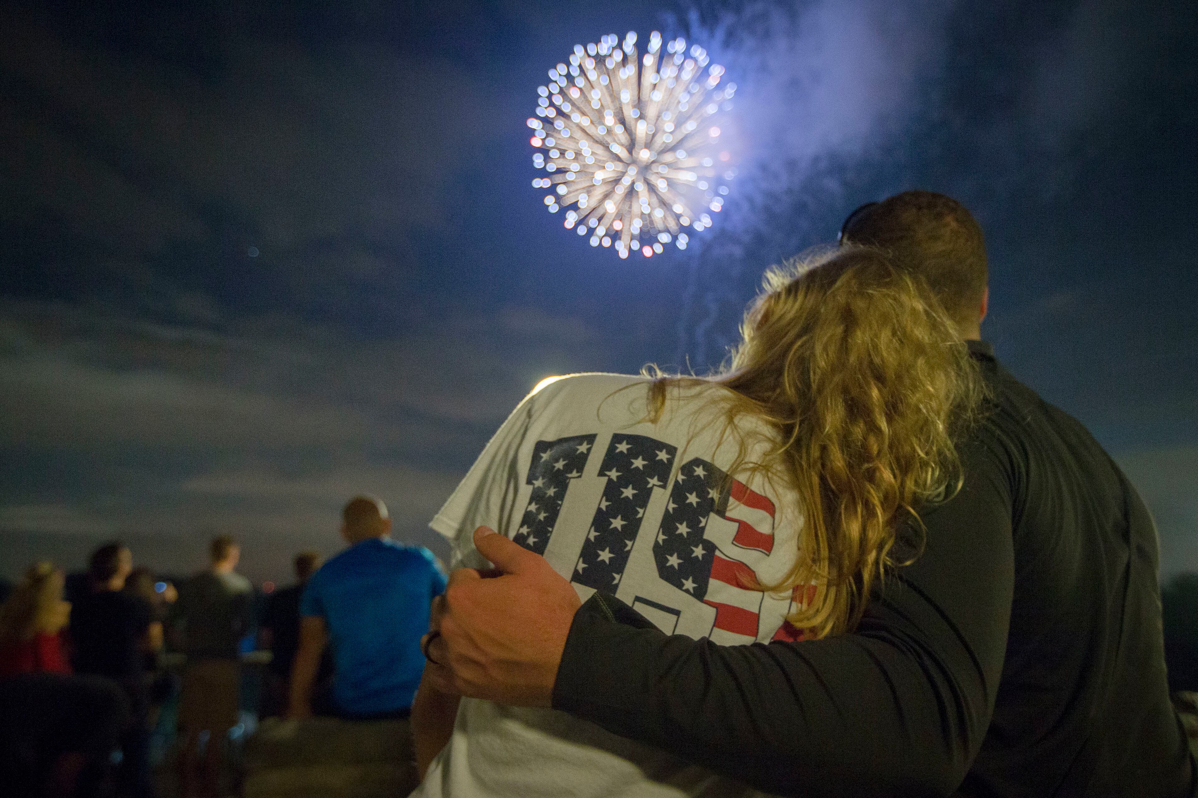 Spectators watch Fourth of July fireworks at Ault Park, Monday, July 4, 2016, in Cincinnati. (AP Photo/John Minchillo)