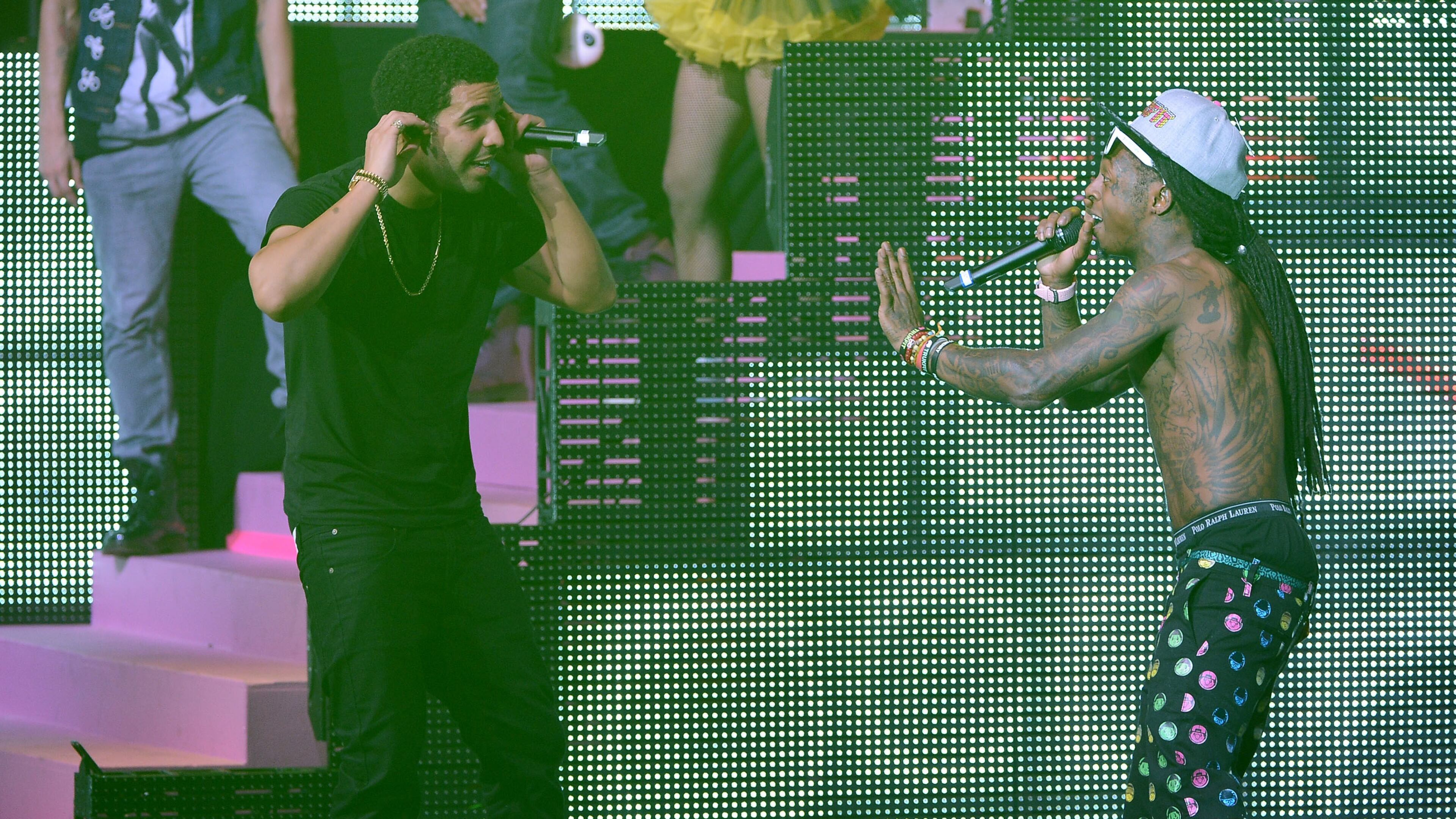 LOS ANGELES, CA - NOVEMBER 30: Rapper and Toronto Raptors team ambassador Drake holds up a finger as a Raptor takes a foul shot against the Los Angeles Lakers at Staples Center on November 30, 2014 in Los Angeles, California. The Lakers 129-122 in overtime. NOTE TO USER: User expressly acknowledges and agrees that, by downloading and or using this photograph, User is consenting to the terms and conditions of the Getty Images License Agreement. (Photo by Stephen Dunn/Getty Images)