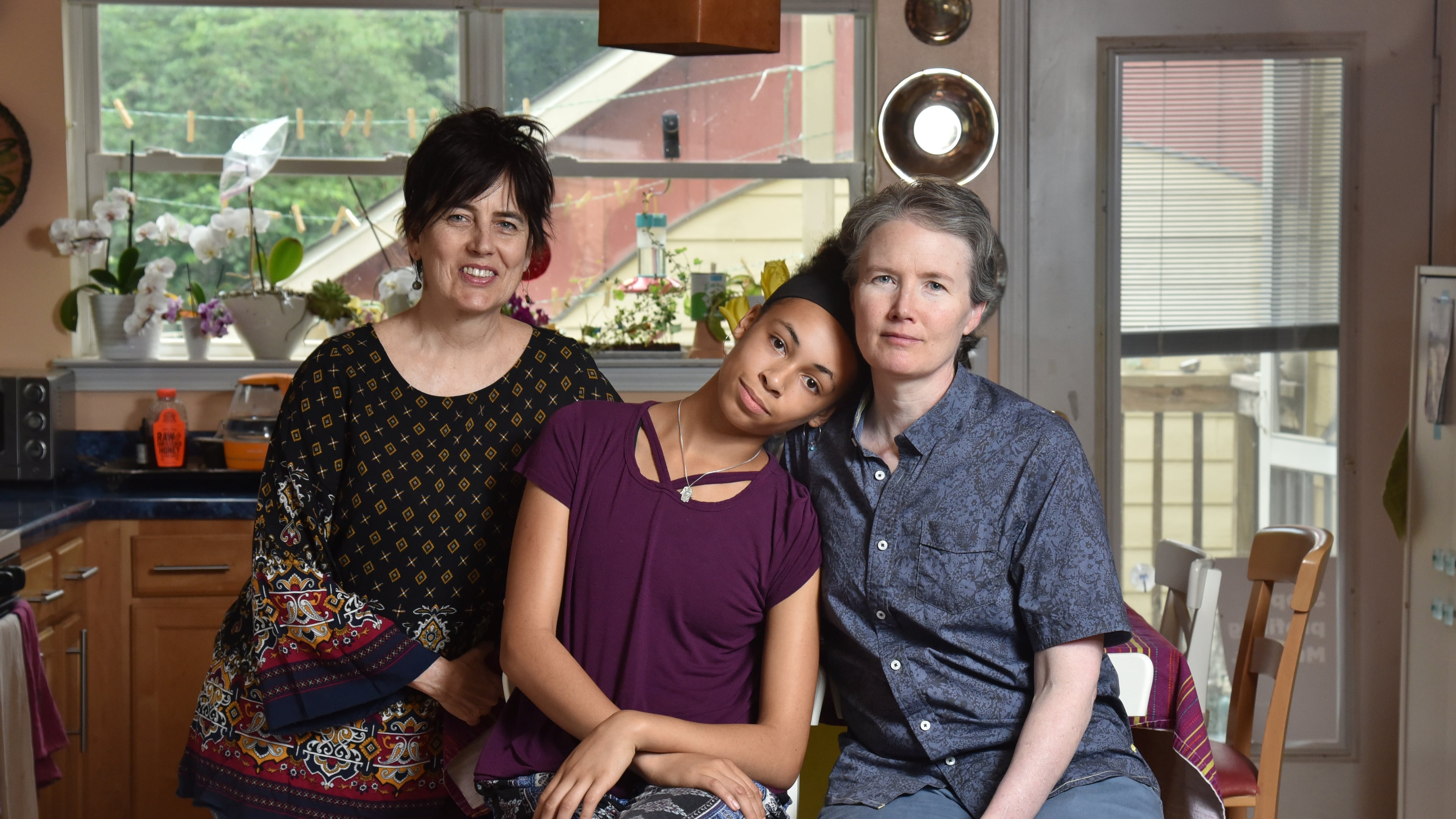 Aliyah Melaver, 15, with her parents Tovah Melaver (left) and Edison Wolf (right) at their home in Decatur on Wednesday, May 15, 2019. HYOSUB SHIN / HSHIN@AJC.COM