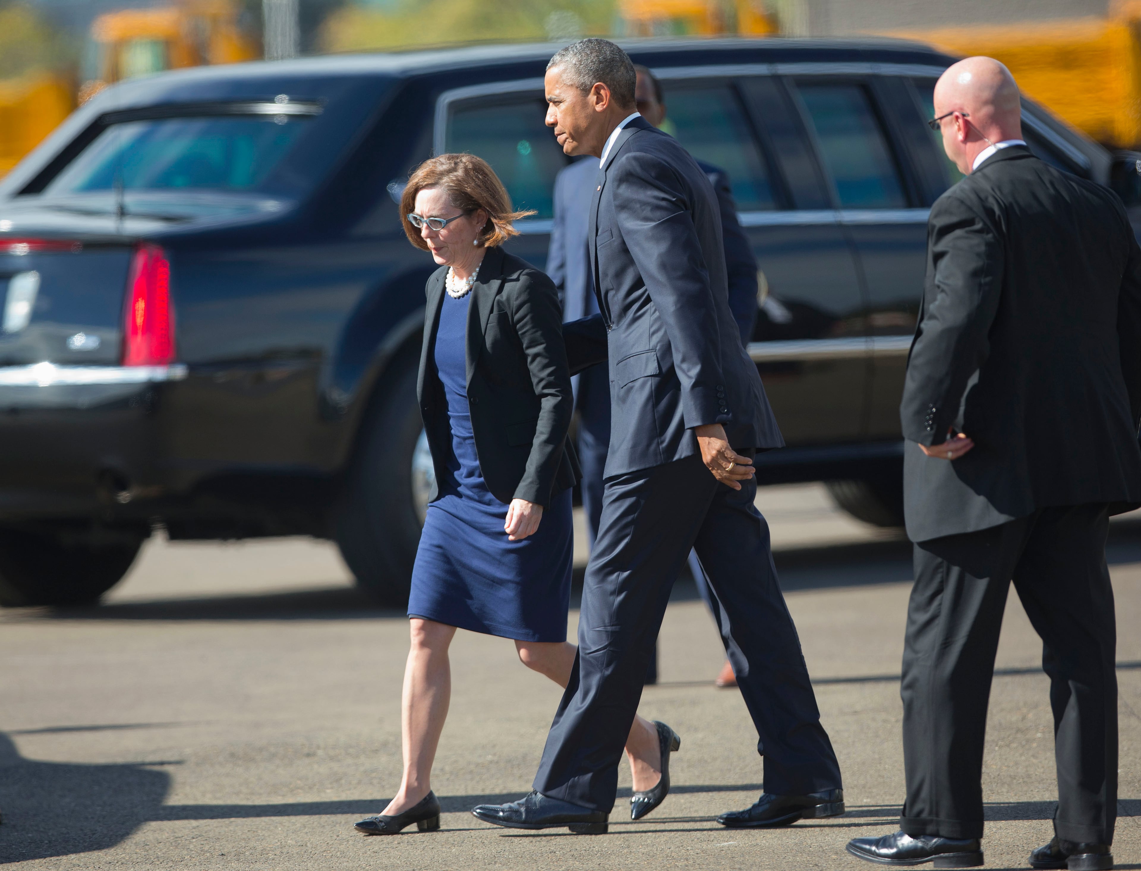 President Barack Obama walks with Oregon Gov. Kate Brown prior to their short motorcade ride to Roseburg H.S., Friday, Oct. 9, 2015 in Roseburg, Ore. Obama traveled to Roseburg to meet with families of the victims of the Oct. 1, shooting at Umpqua Community College, as part of a four-day West Coast tour. Obama is also scheduled to attend a fundraiser event later today in Seattle with Sen. Patty Murray, D-Wash. He's is also attending fundraisers in San Francisco and Los Angeles during the four-day visit. (AP Photo/Pablo Martinez Monsivais)
