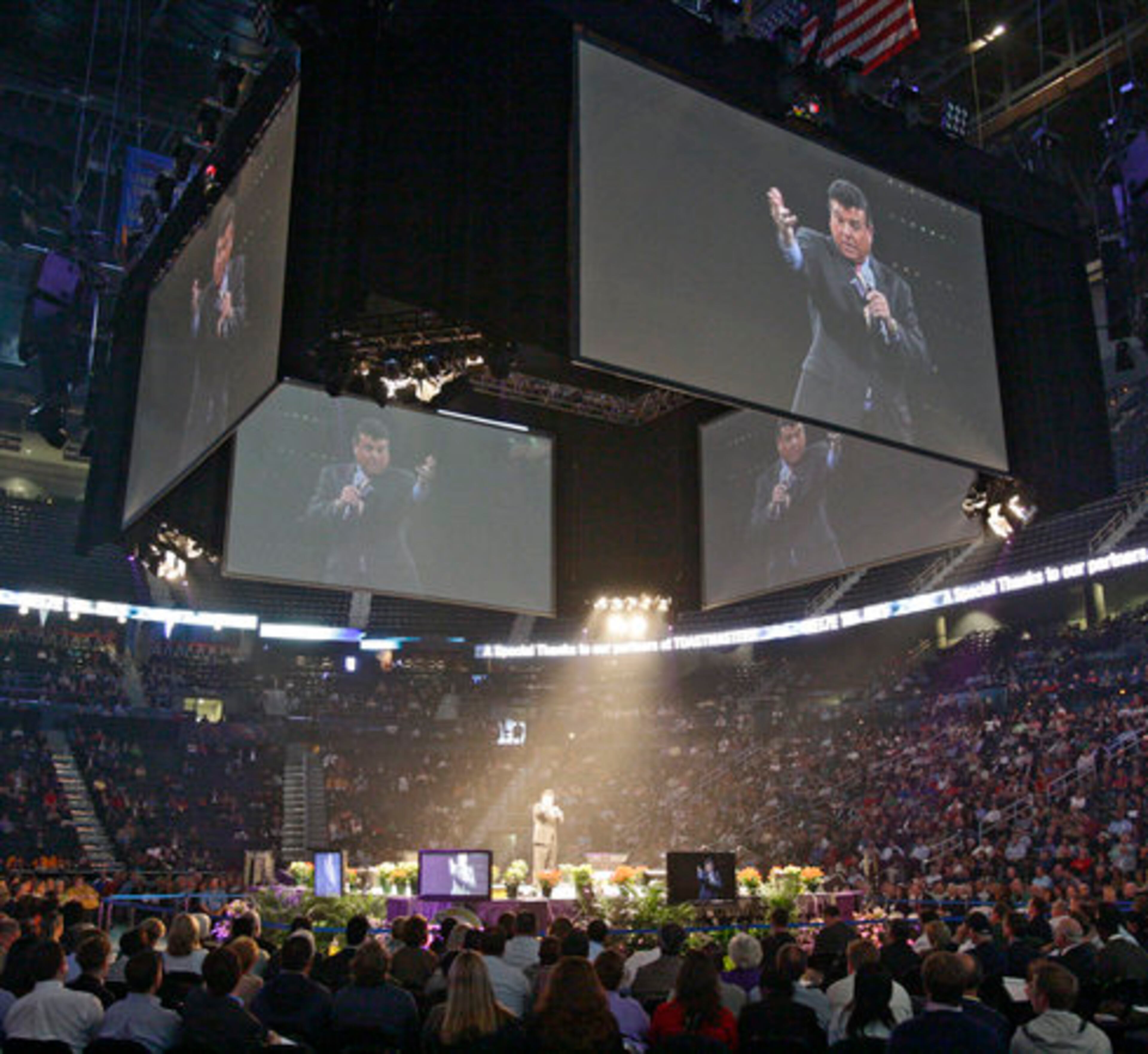 Tom Hopkins, who worked his way up selling real estate and authored eight books, is seen on the big screen in the center of Philips Arena.