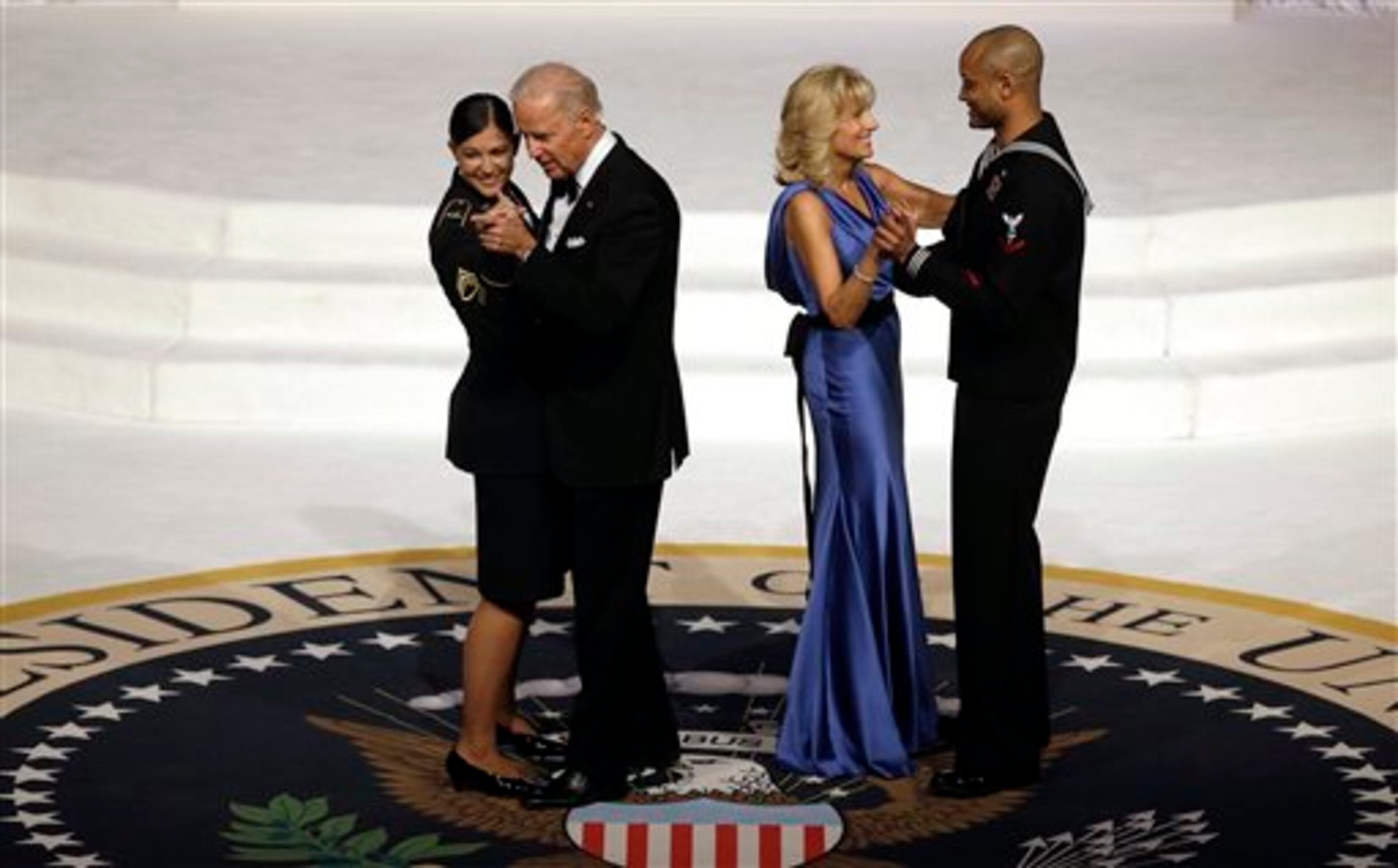 Vice President Joe Biden dances with Army Staff Sgt. Keesha Dentino as Jill Biden dances with Navy Petty Officer 3rd Class Patrick Figueroa during the Commander-In-Chief inaugural ball at the Washington Convention Center during the 57th Presidential Inauguration Monday, Jan. 21, 2013 in Washington. (AP Photo/ Evan Vucci)
