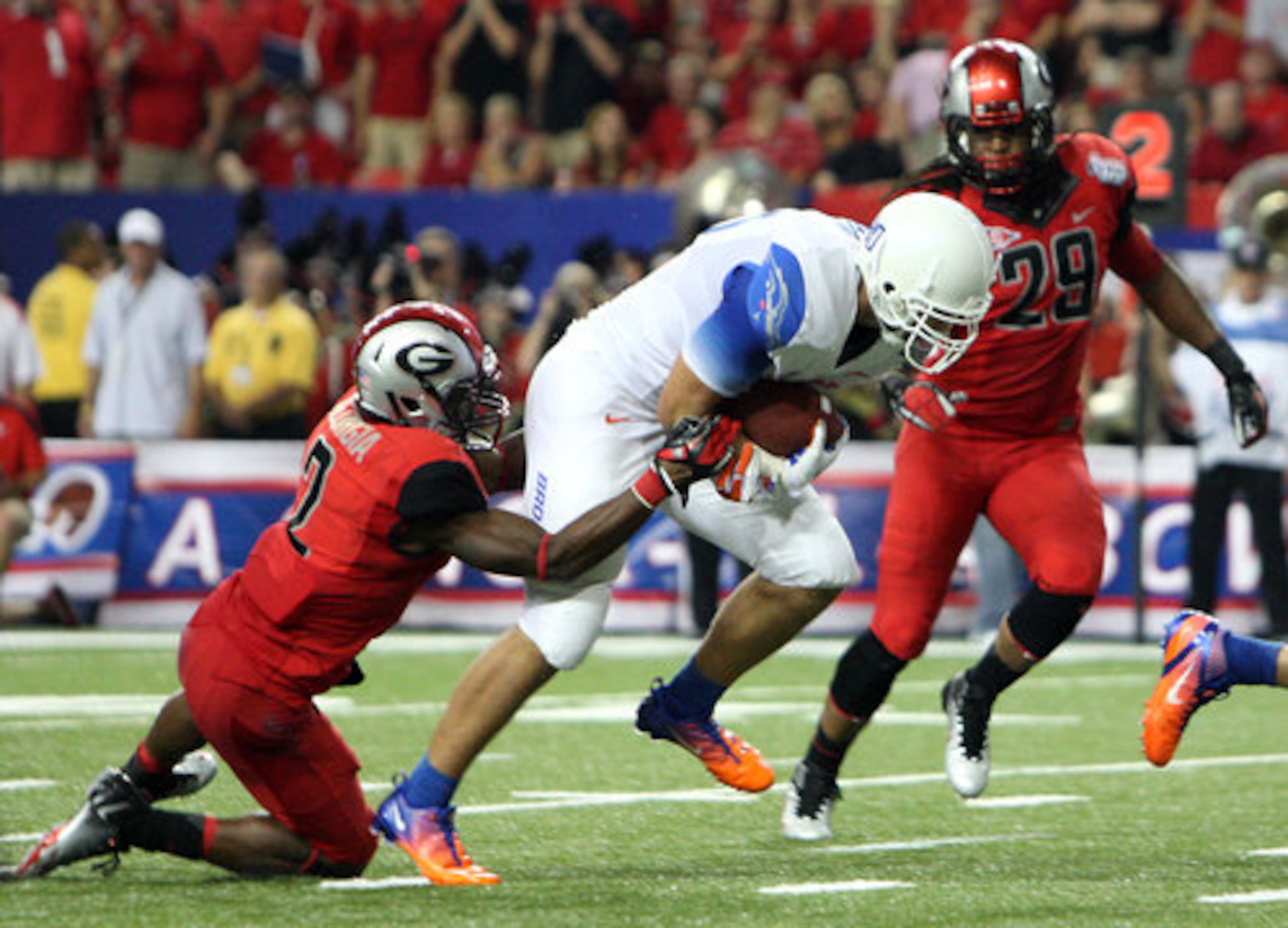 Boise State tight end Kyle Efaw, center, gets past Georgia defensive back Brandon Boykin for a 12-yard touchdown from Kellen Moore.