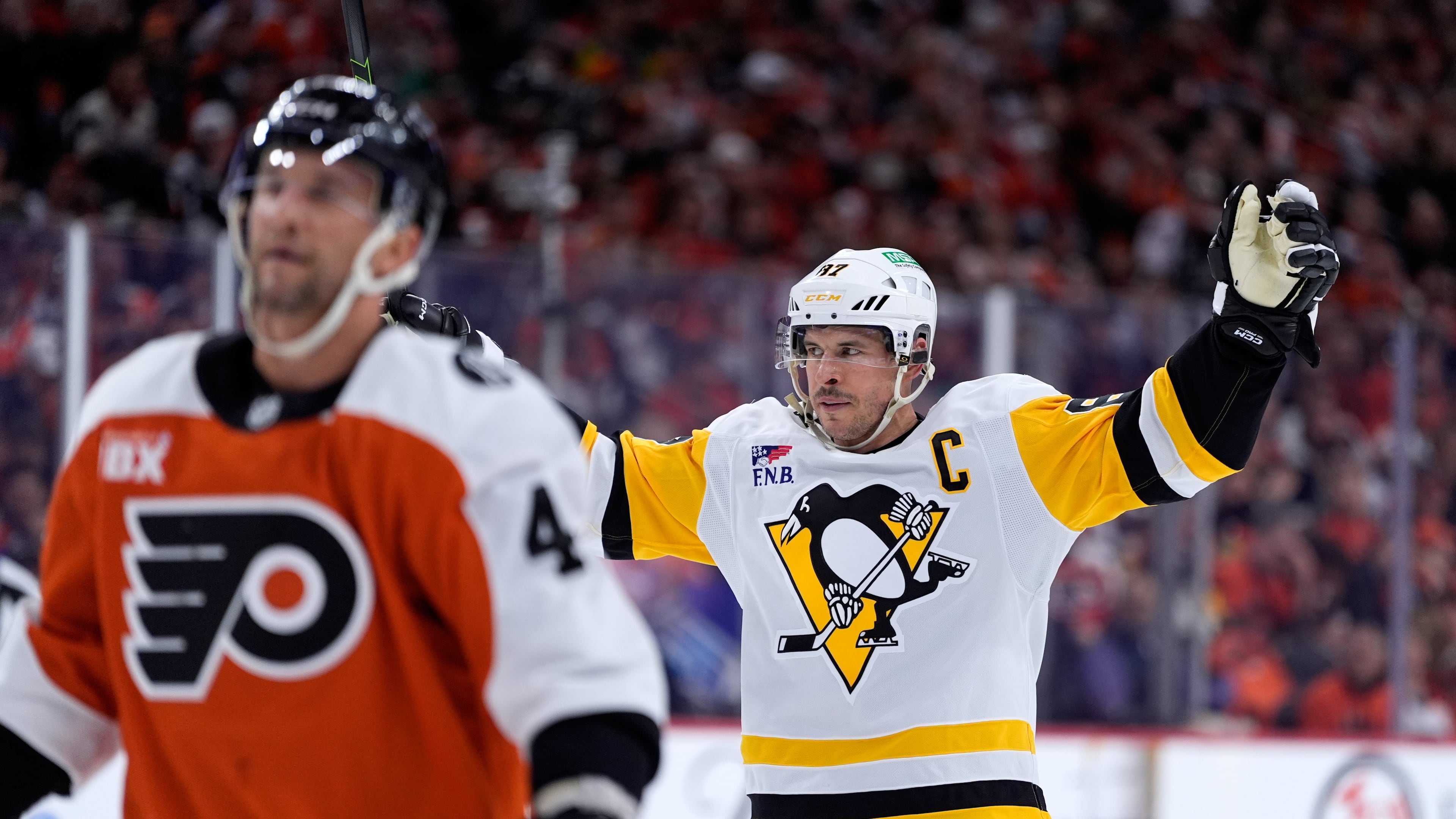 Pittsburgh Penguins' Sidney Crosby, right, reacts behind Philadelphia Flyers' Luke Glendening after scoring during the first period of Game 4 in the first round of the NHL Stanley Cup hockey playoff series Saturday, April 25, 2026, in Philadelphia. (AP Photo/Matt Slocum)