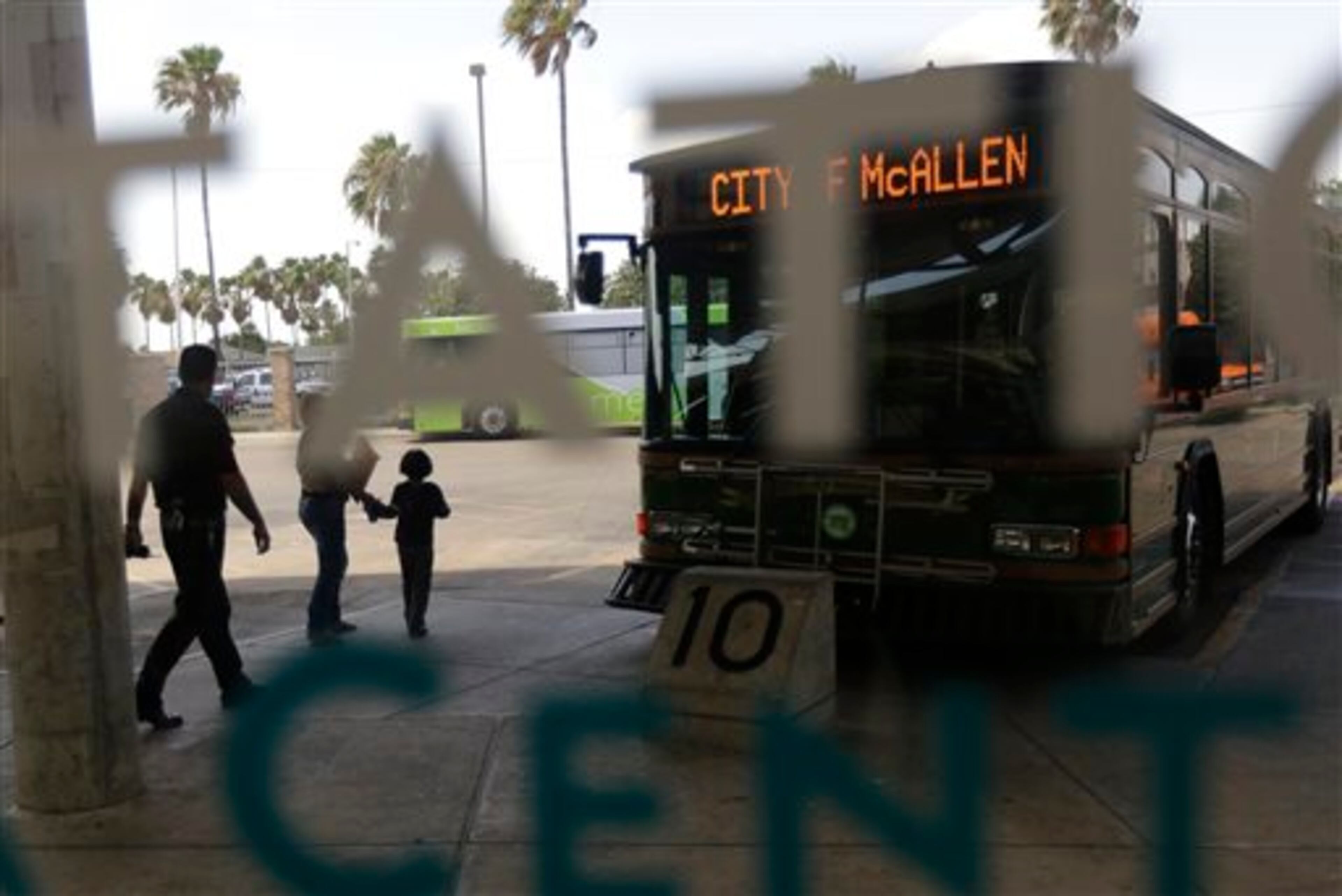 In this June 20, 2014 photo, immigrants who entered the U.S. illegally depart the bus station in McAllen, Texas. The immigrants entered the country through an area referred to as zone nine. (AP Photo/Eric Gay)