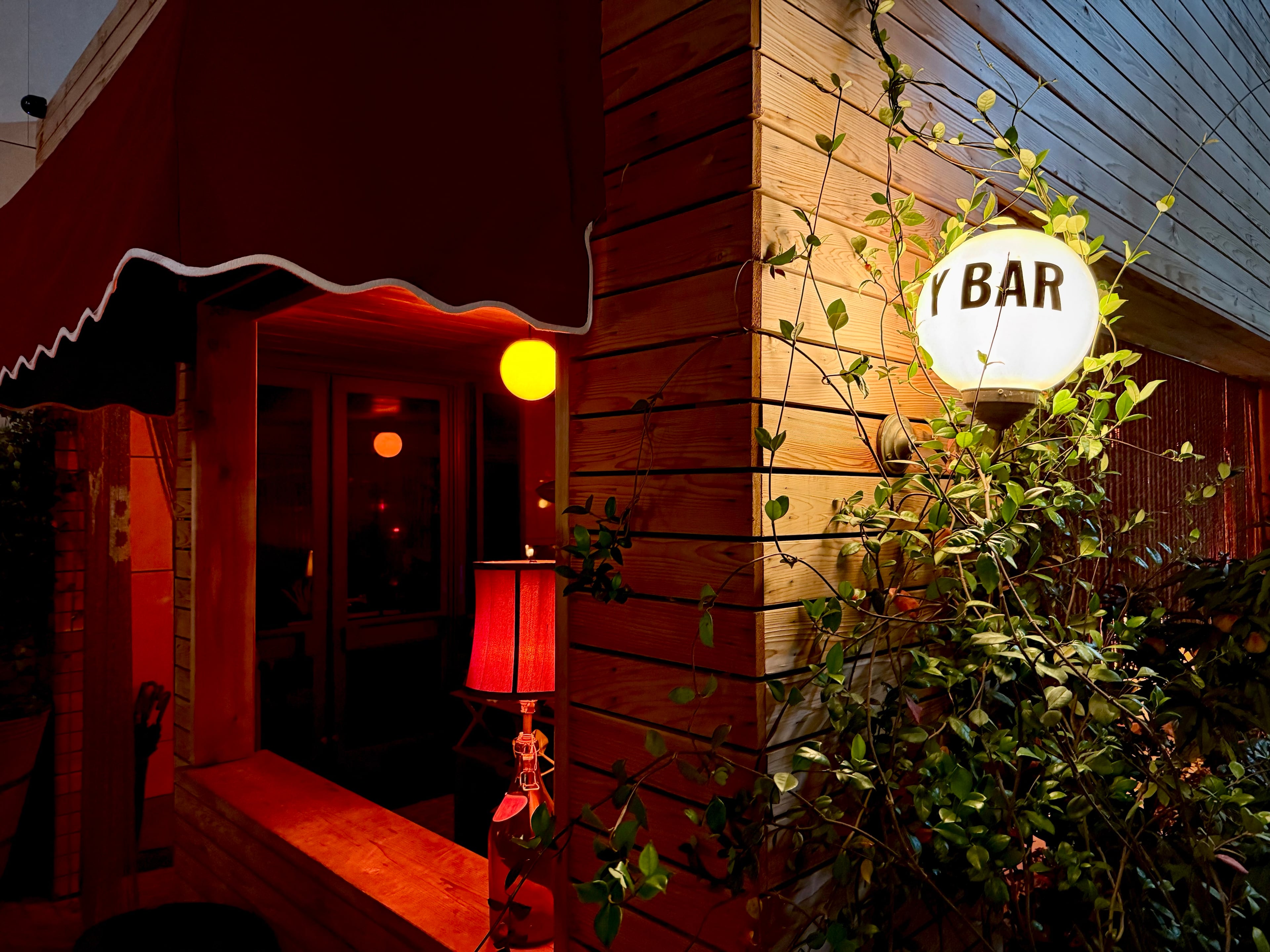 The exterior of Y Bar e Ristorante, which has a narrow, terraced patio leading to its front door. (Henri Hollis/AJC)
