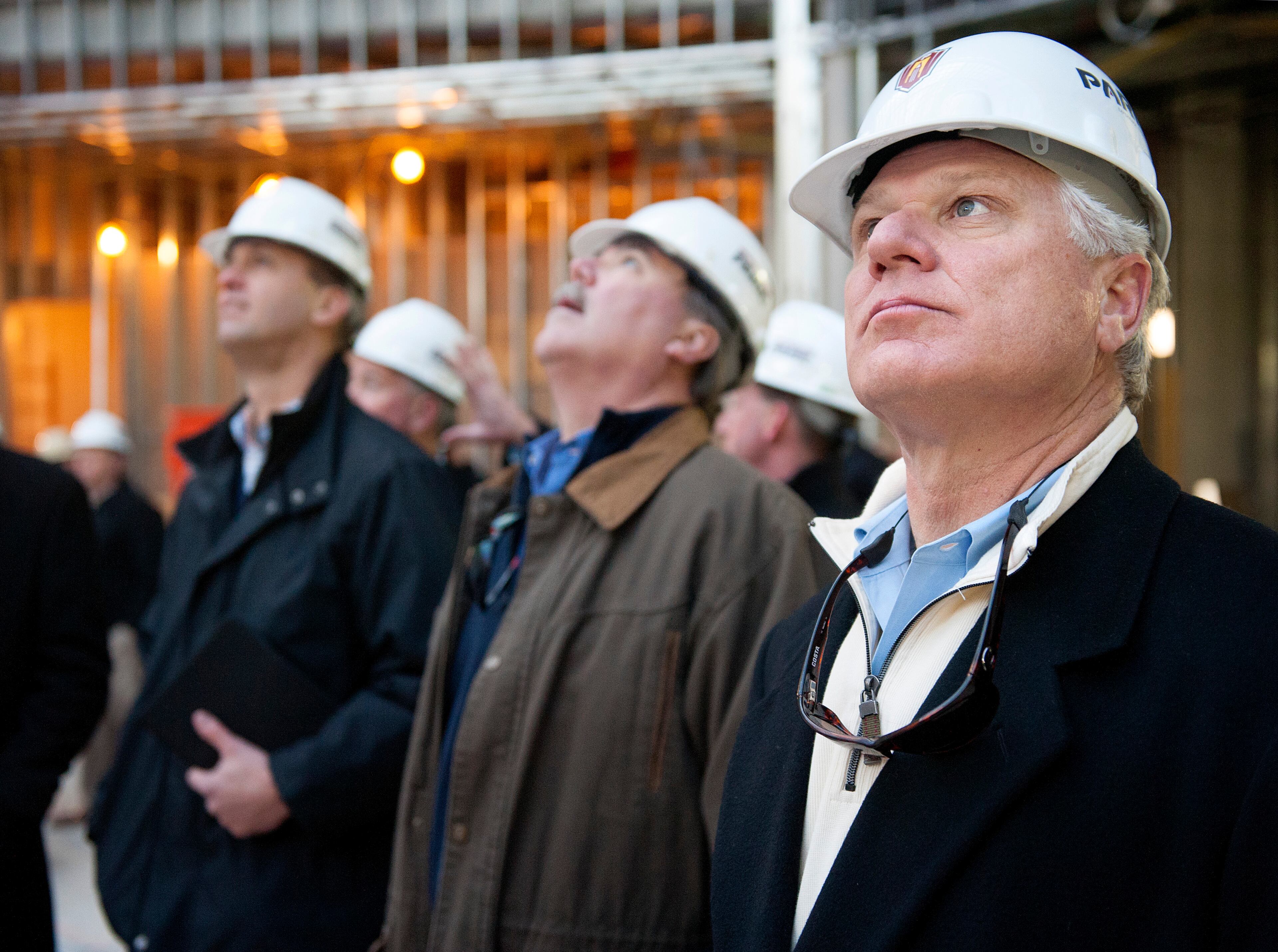 17 DEC. 2013 -- ST. LOUIS -- Atlanta Braves General Manager Frank Wren (right) joins Braves Executive Vice President of Business Operations Mike Plant (center) and Braves Executive Vice President of Sales and Marketing Derek Schiller (right) during a tour of Ballpark Village in St. Louis, a joint development of the St. Louis Cardinals and the Cordish Companies adjacent to Bush Stadium, Tuesday, Dec. 17, 2013. The development is slated to open in phases beginning in March 2014 after several years of delays. Photo by Sid Hastings.